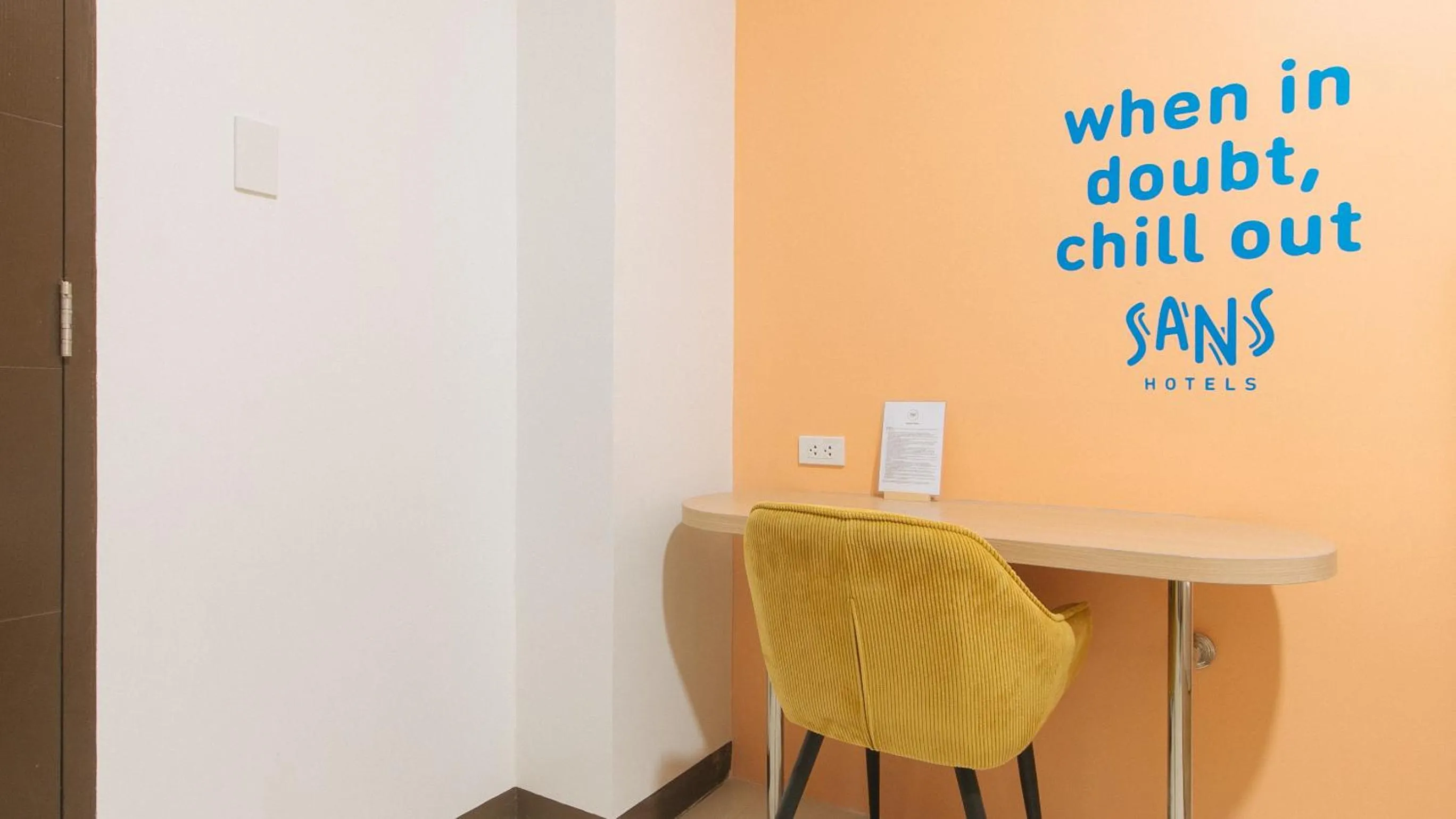 Seating area in Sans Hotel at One JD Place Makati by RedDoorz