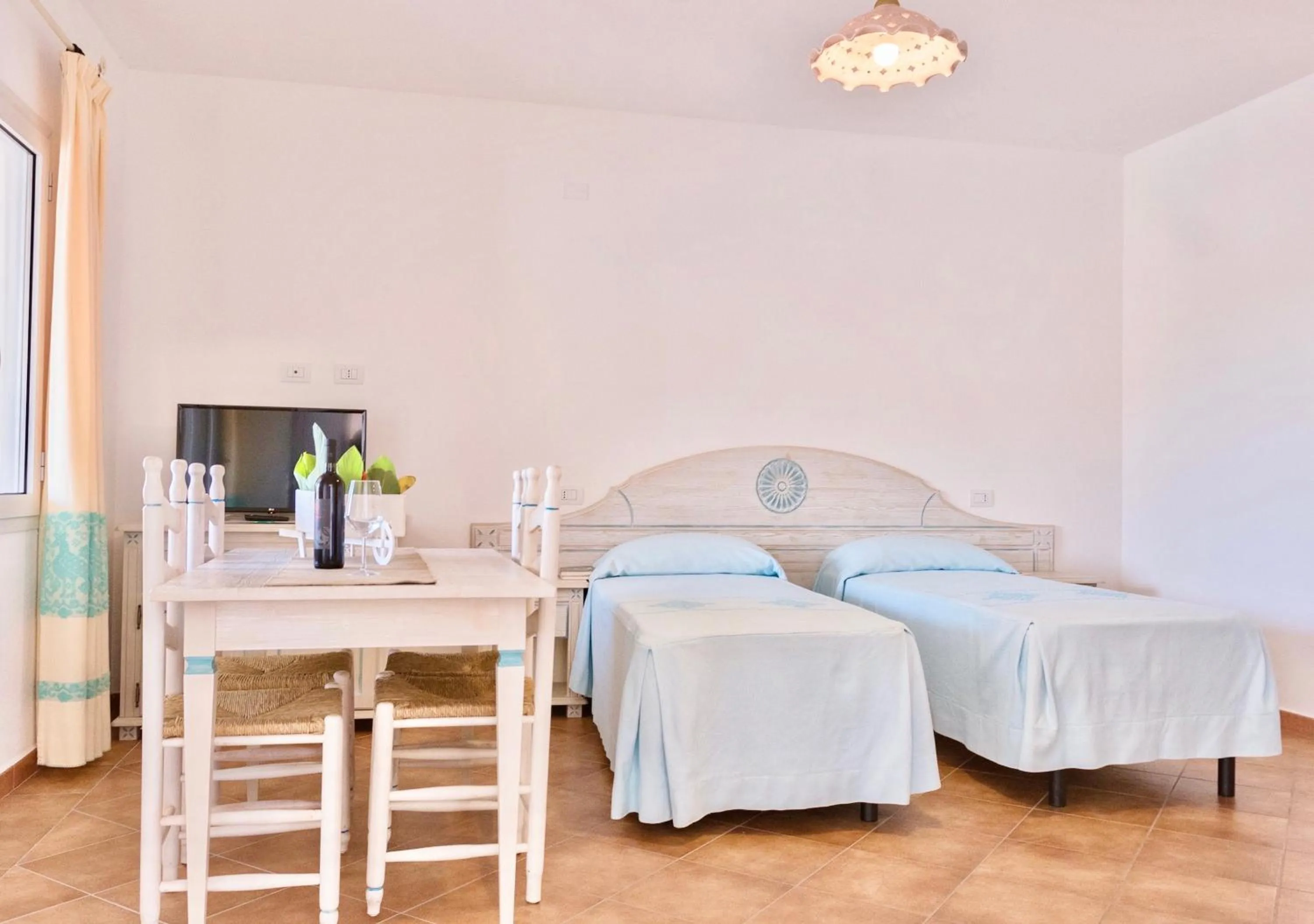 Living room, Bed in Apartments with air conditioning in Orosei