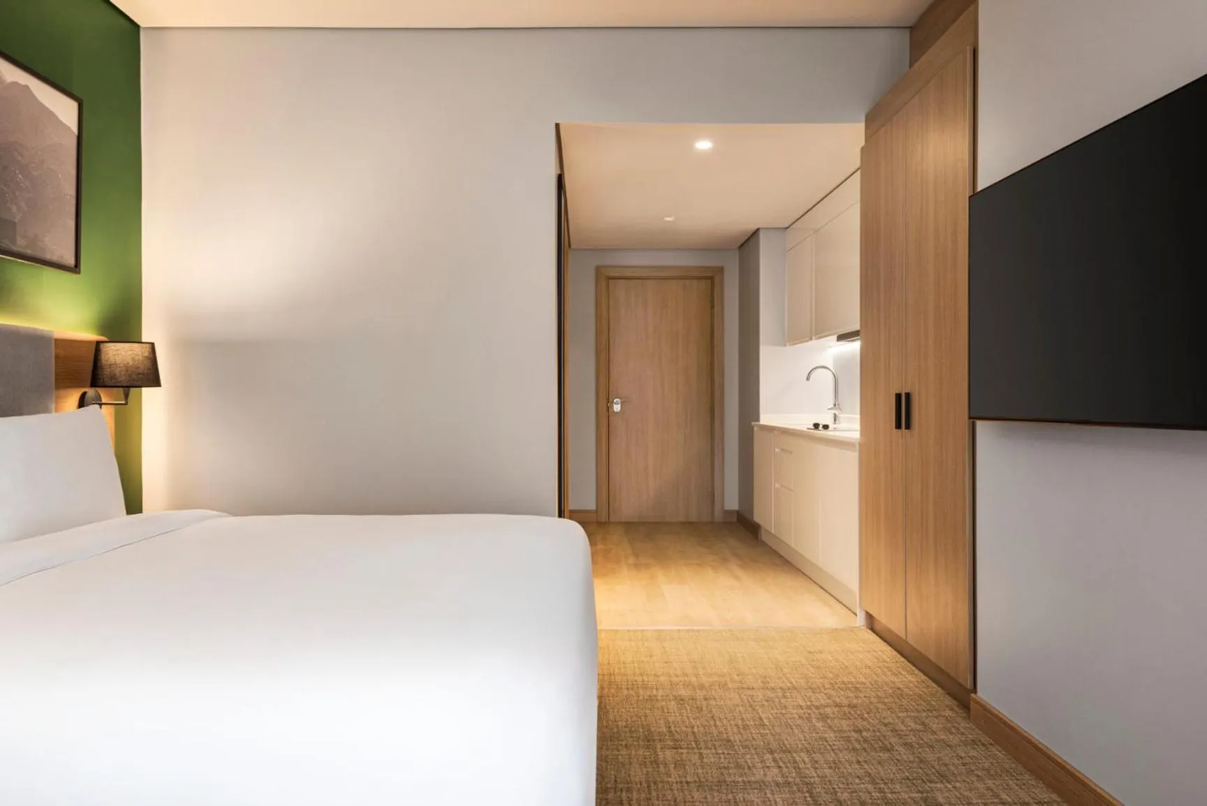 Kitchen or kitchenette, Bed in Radisson Hotel & Residence Riyadh Olaya