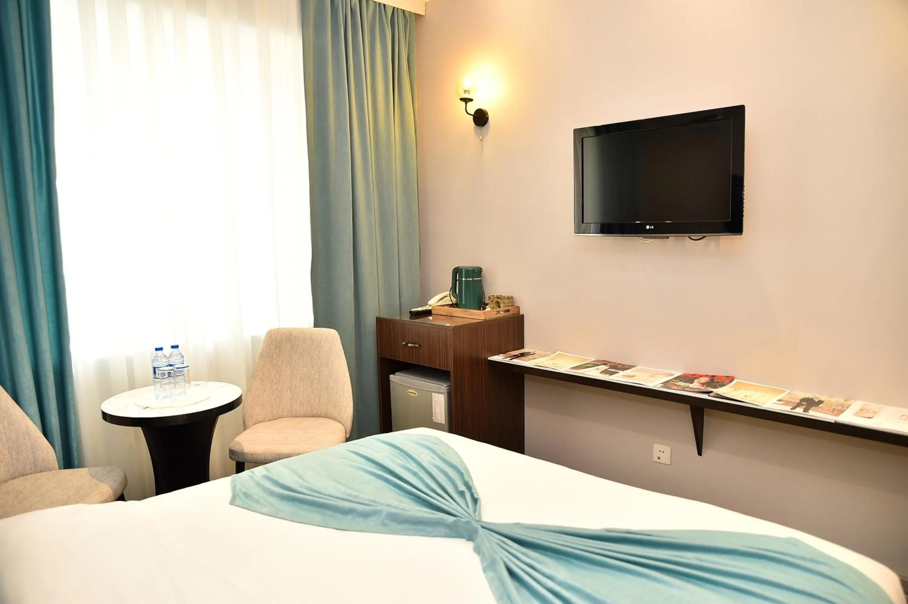 Bed in Karat Inn Boutique Hotel