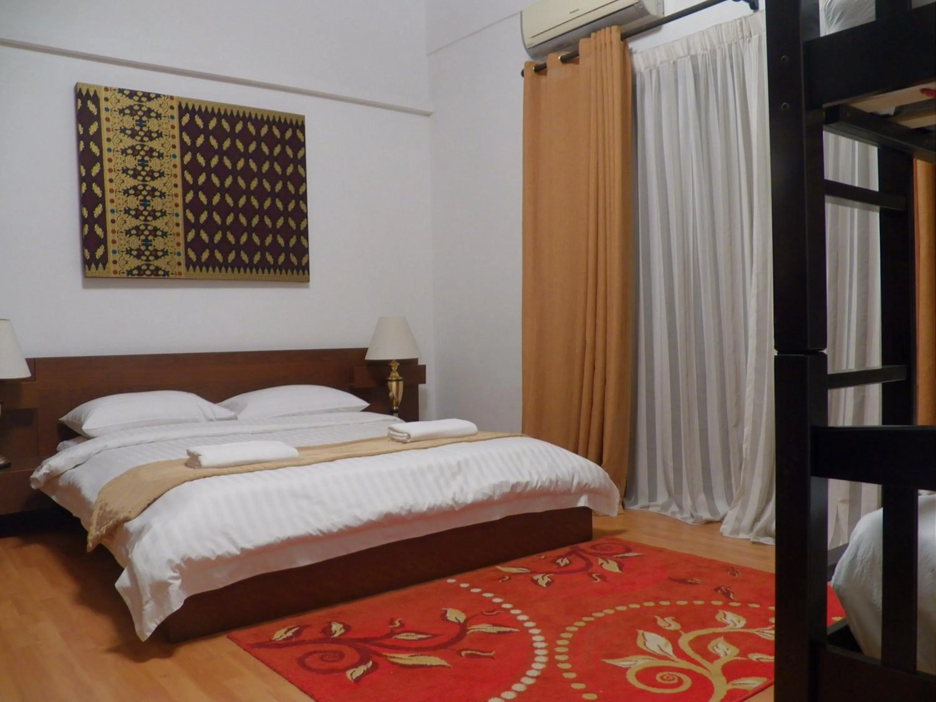 Bed in Maytower Apartment