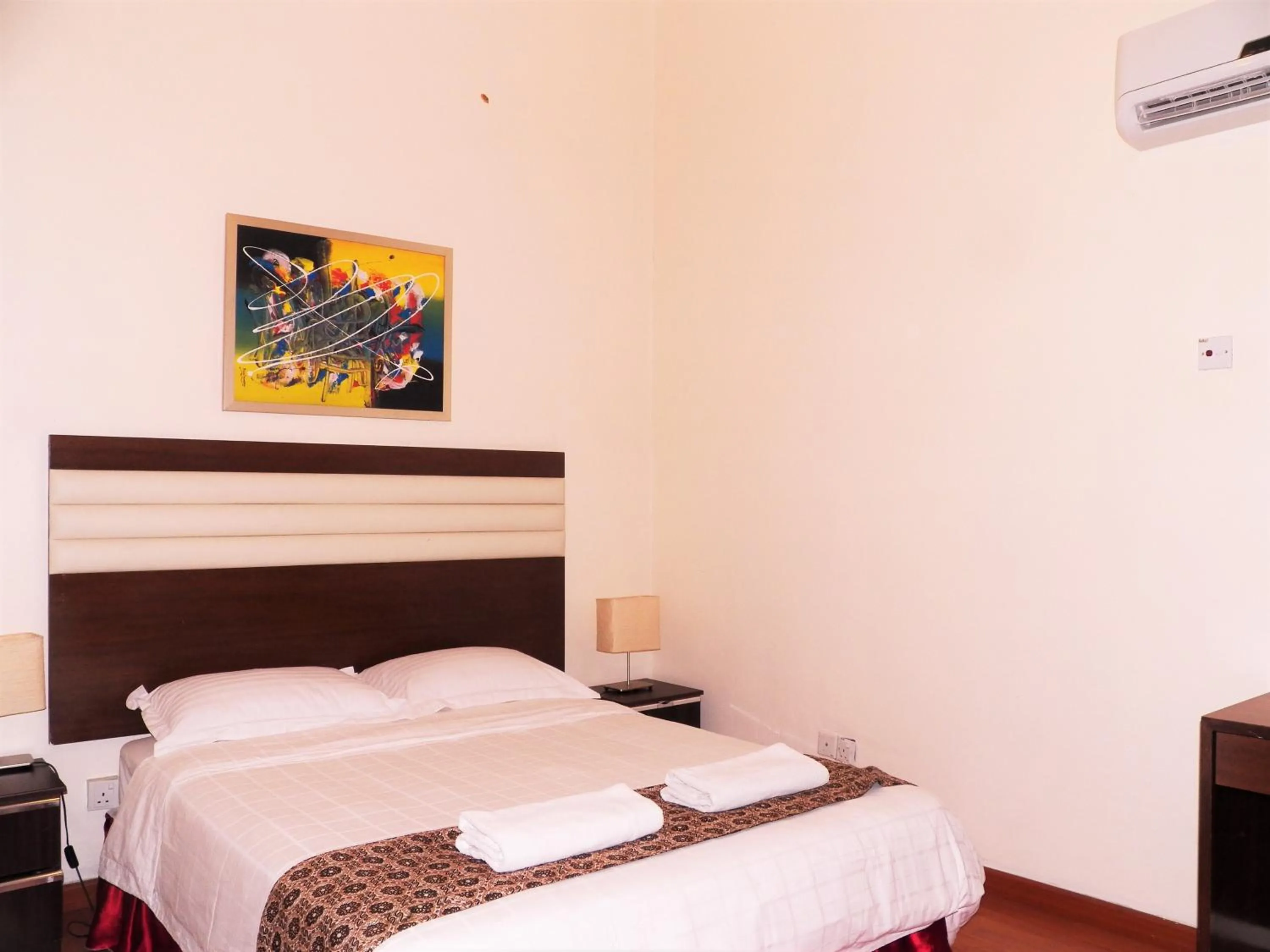 Bed in Maytower Apartment