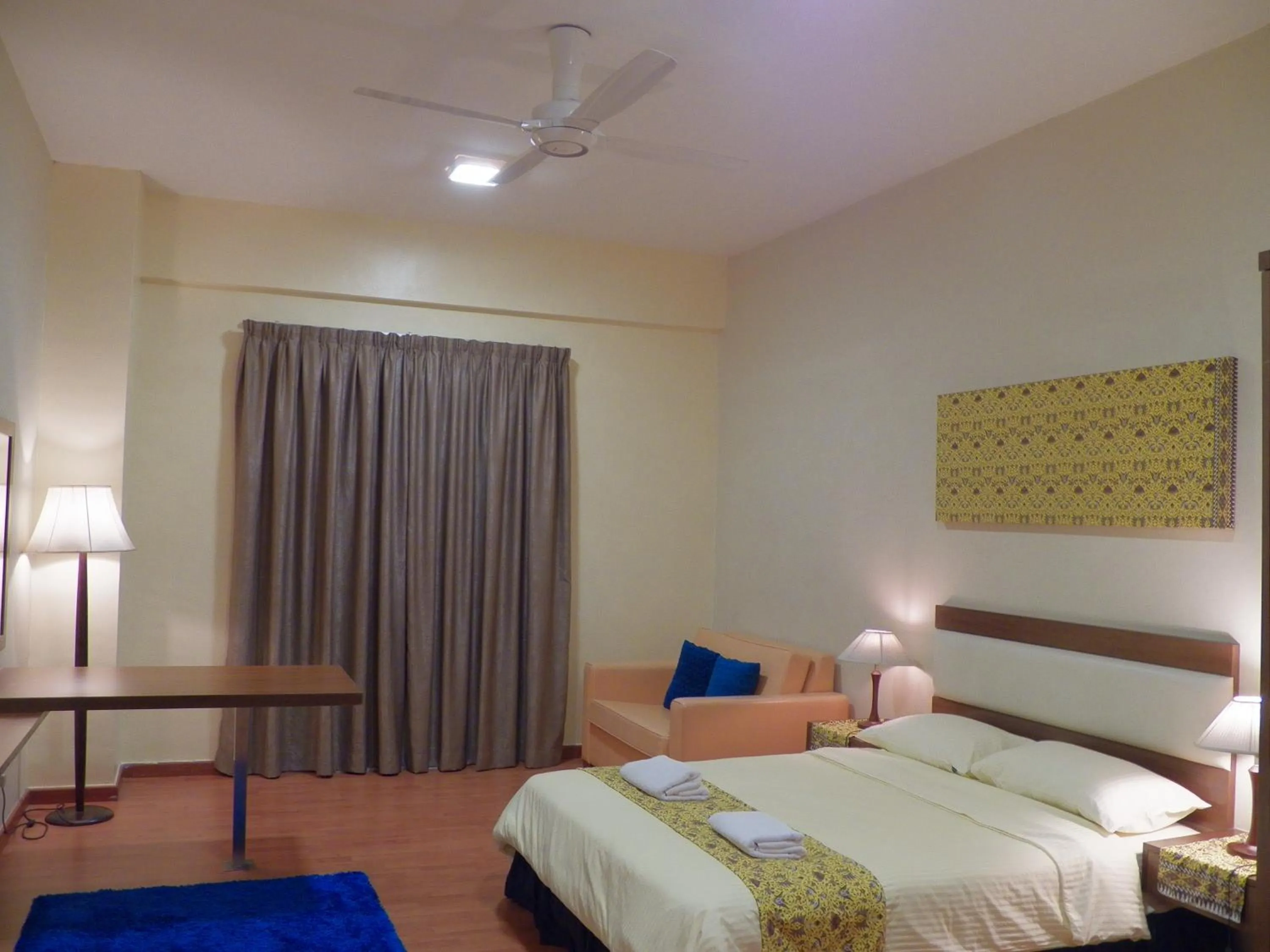 Bed in Maytower Apartment