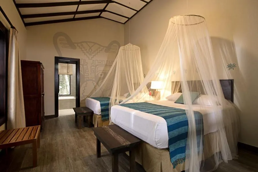 Bed in Hotel Jungle Lodge Tikal