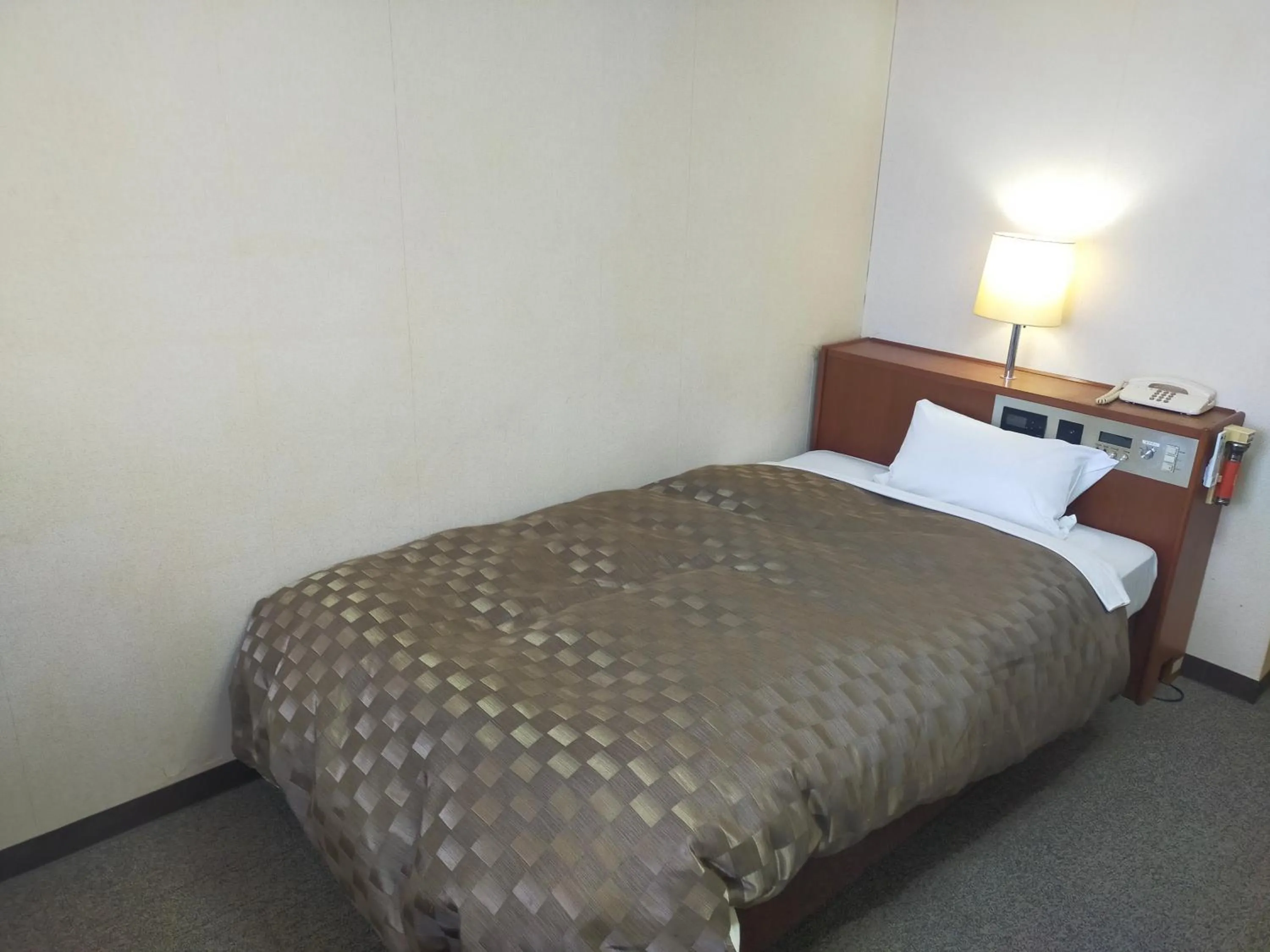 Bed in Hotel Kurashiki Mizushima Hills
