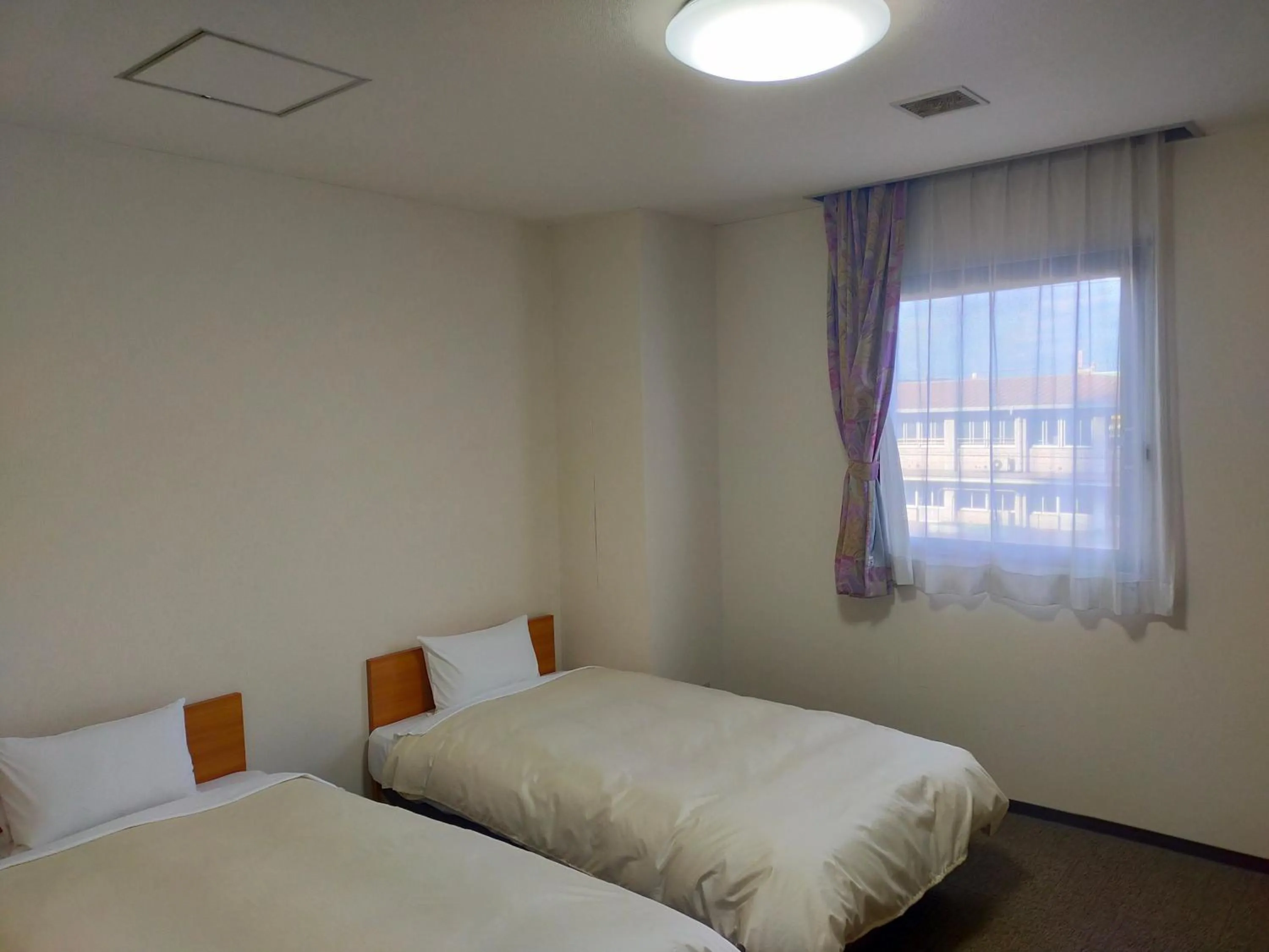 Bed in Hotel Kurashiki Mizushima Hills