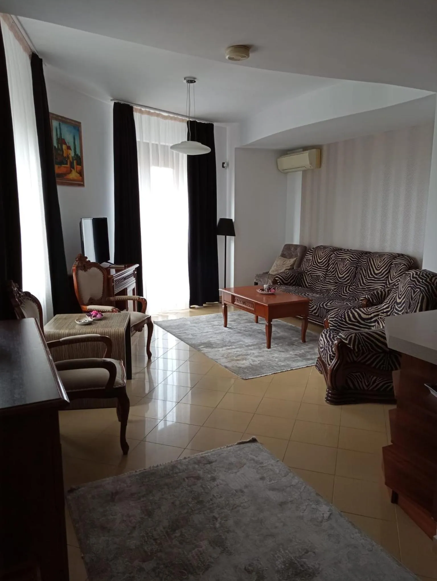 Communal lounge/ TV room in El Locanda Boutique Hotel