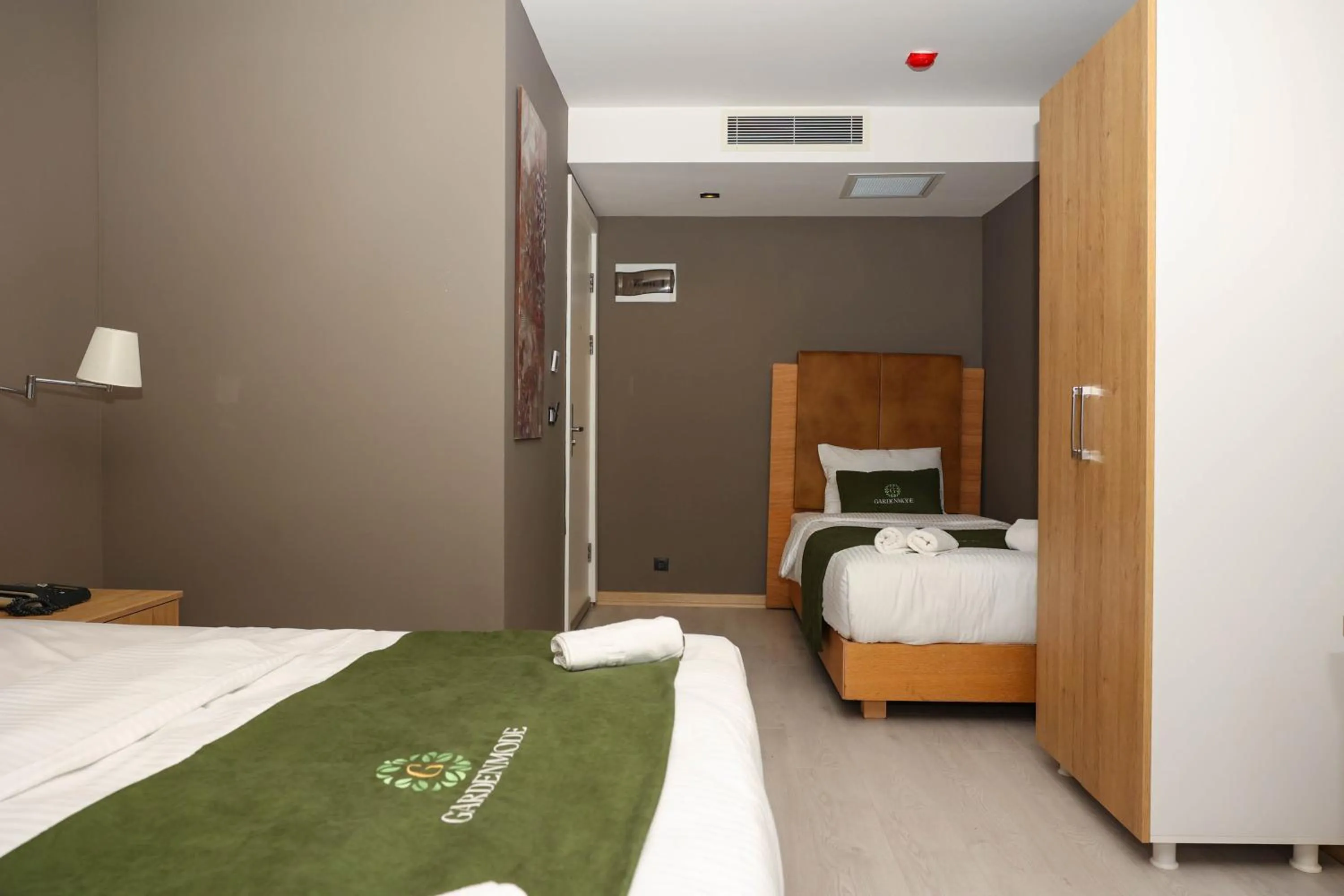 Bed in Gardenmode Airport Hotel