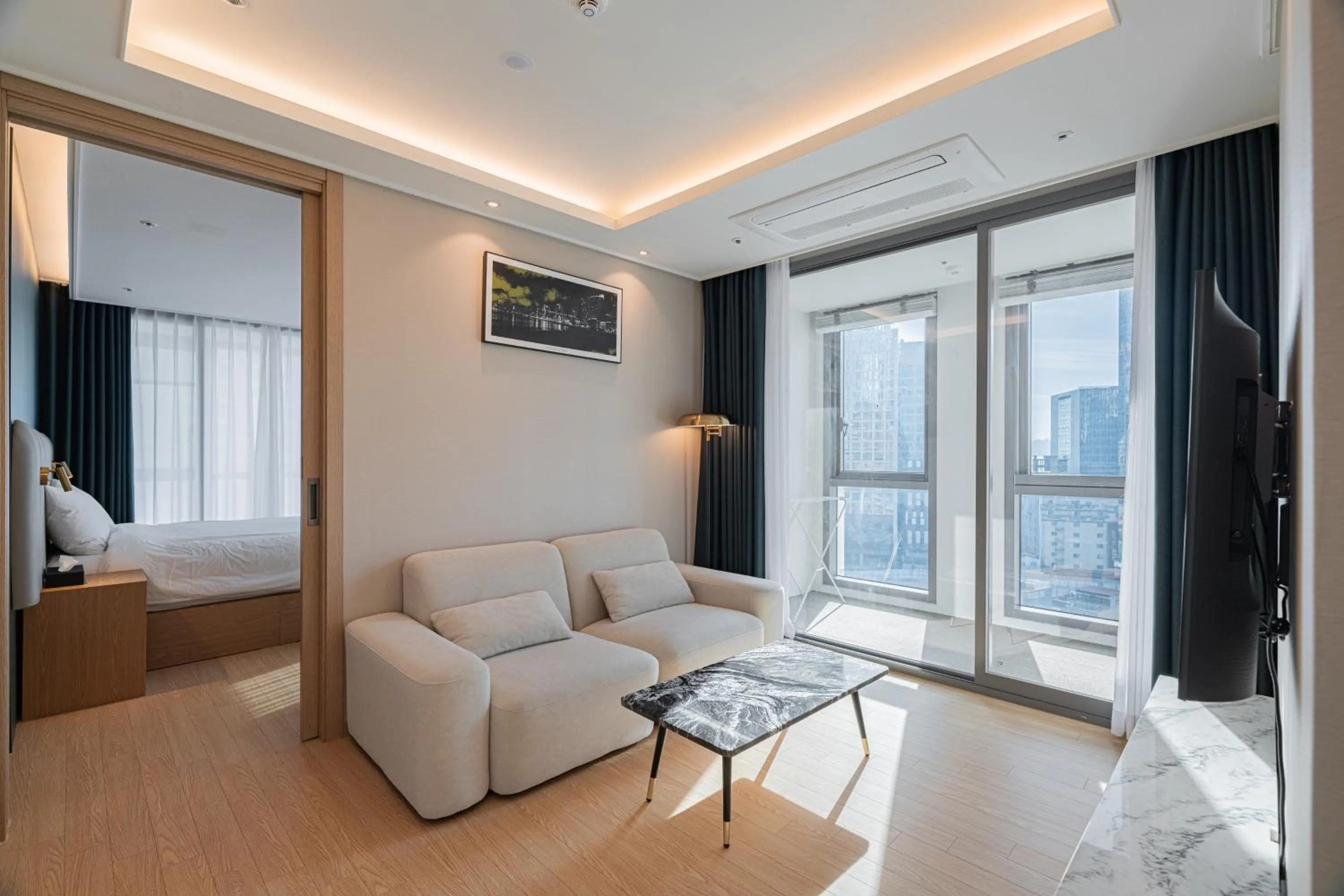 Living room, Bed in The solid residence - Elbon the stay by haeundae