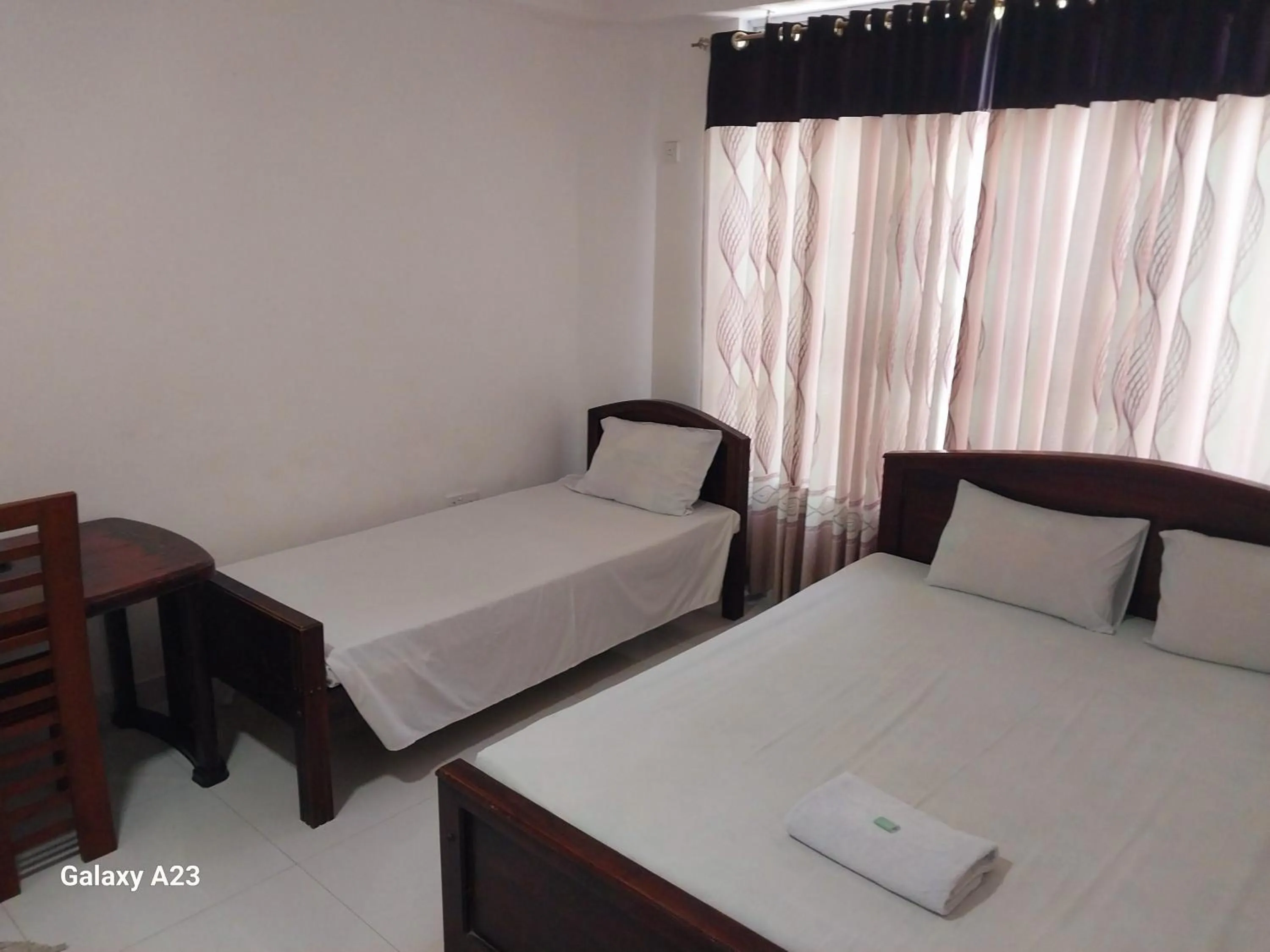 Bed in Senanayaka Holiday Inn