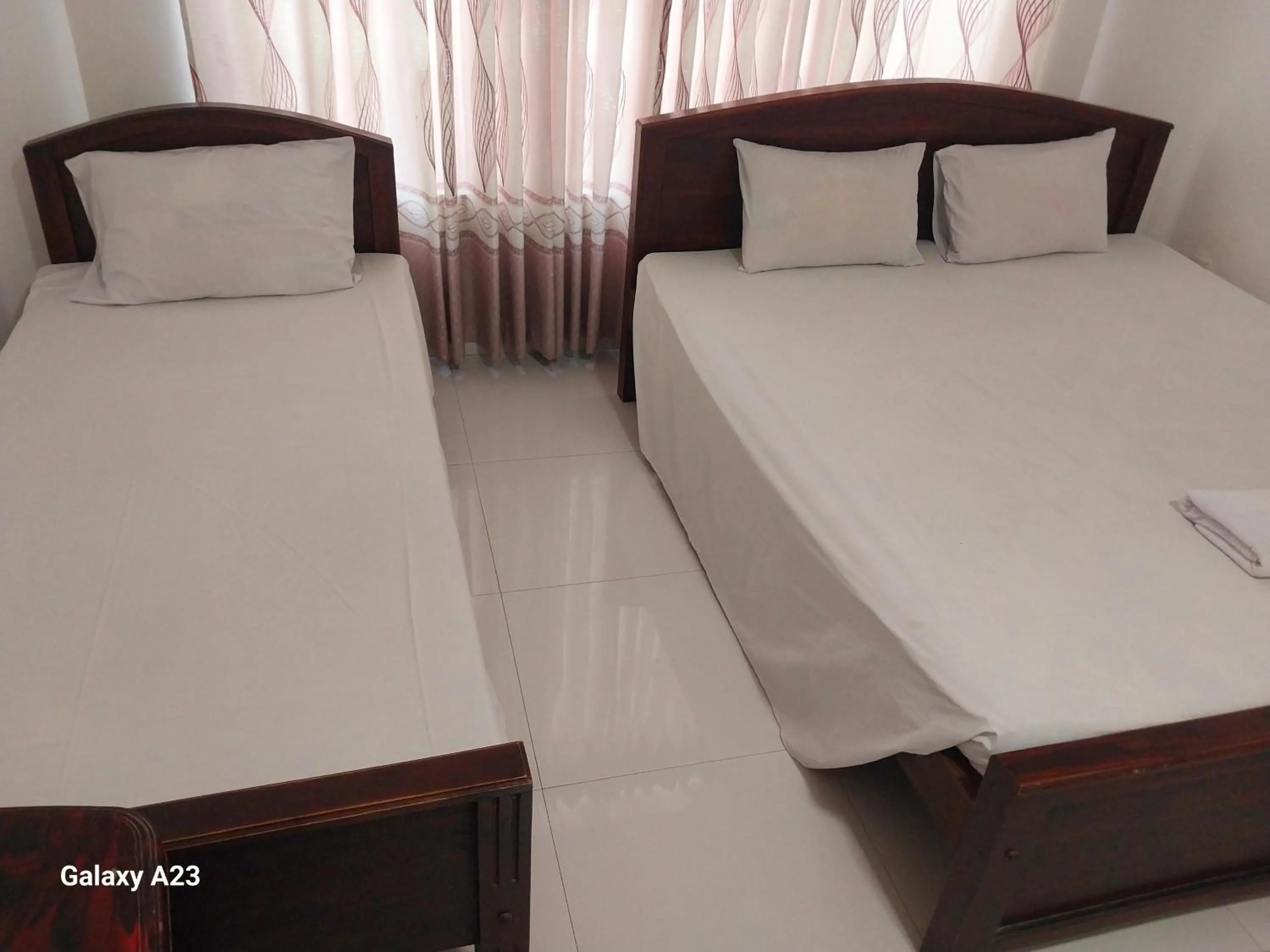 Bed in Senanayaka Holiday Inn