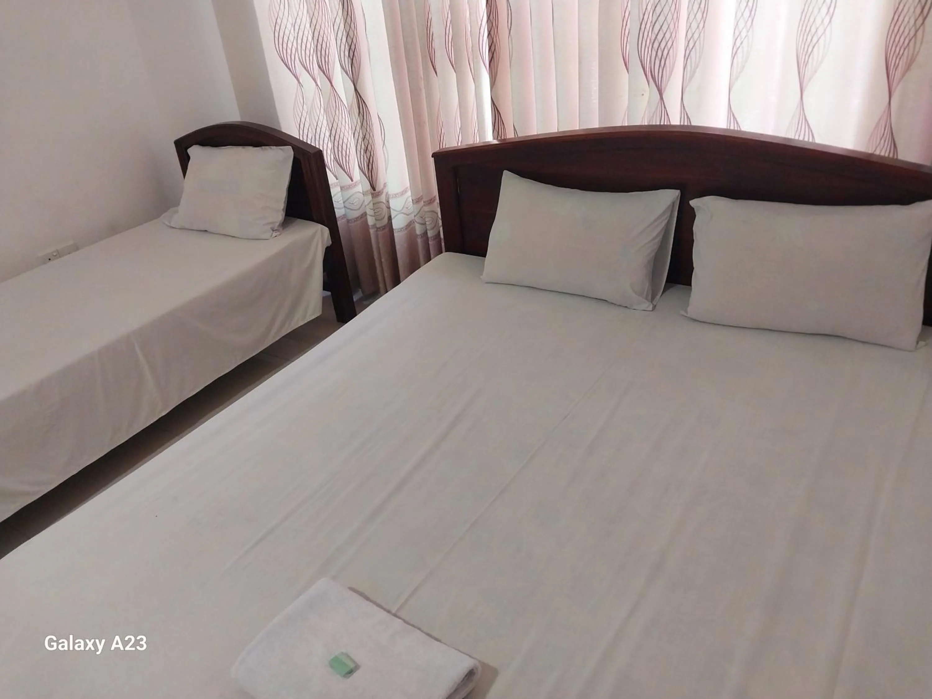 Bed in Senanayaka Holiday Inn