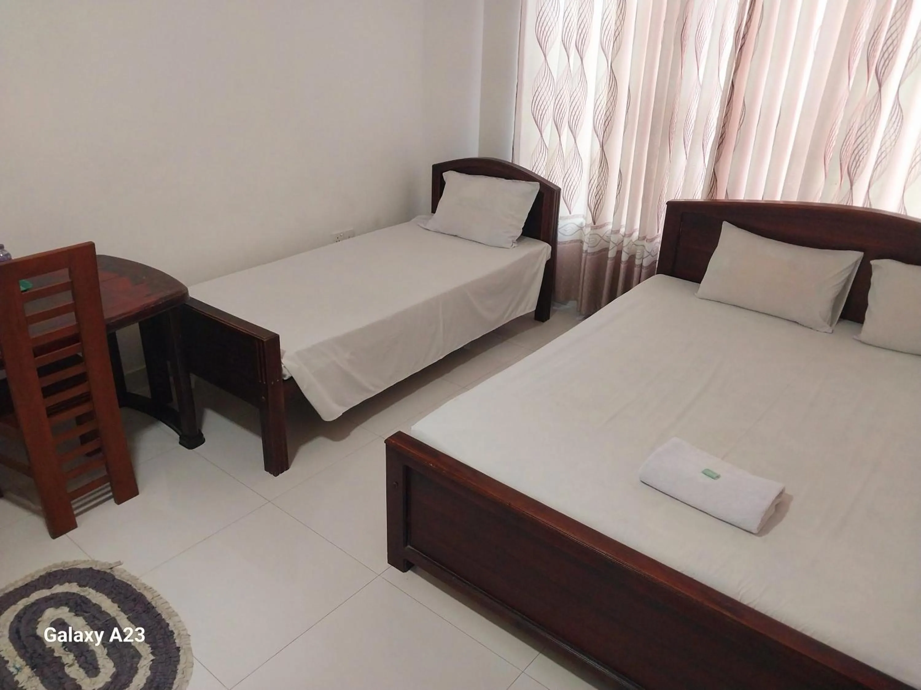 Bed in Senanayaka Holiday Inn