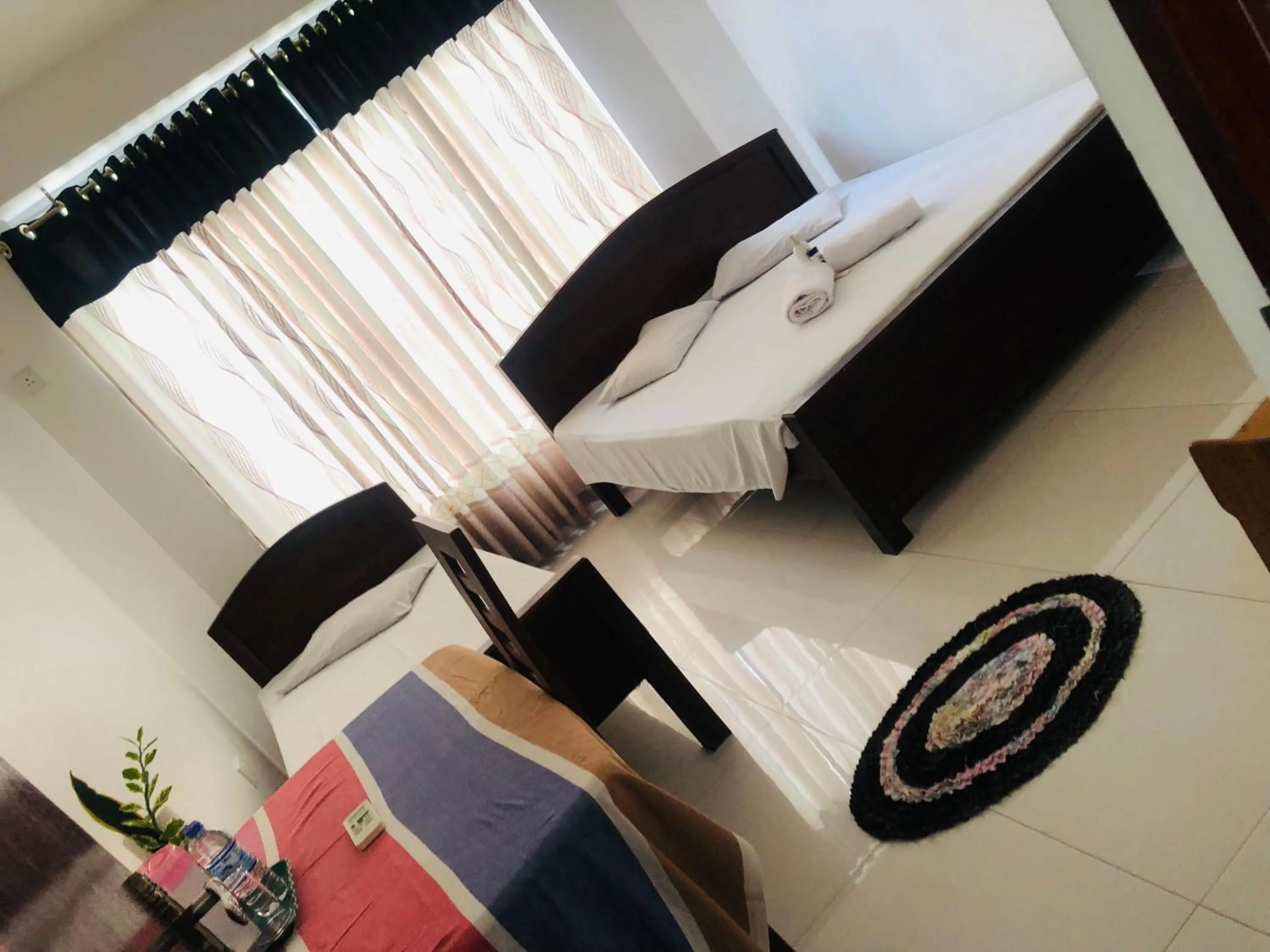 Bed in Senanayaka Holiday Inn