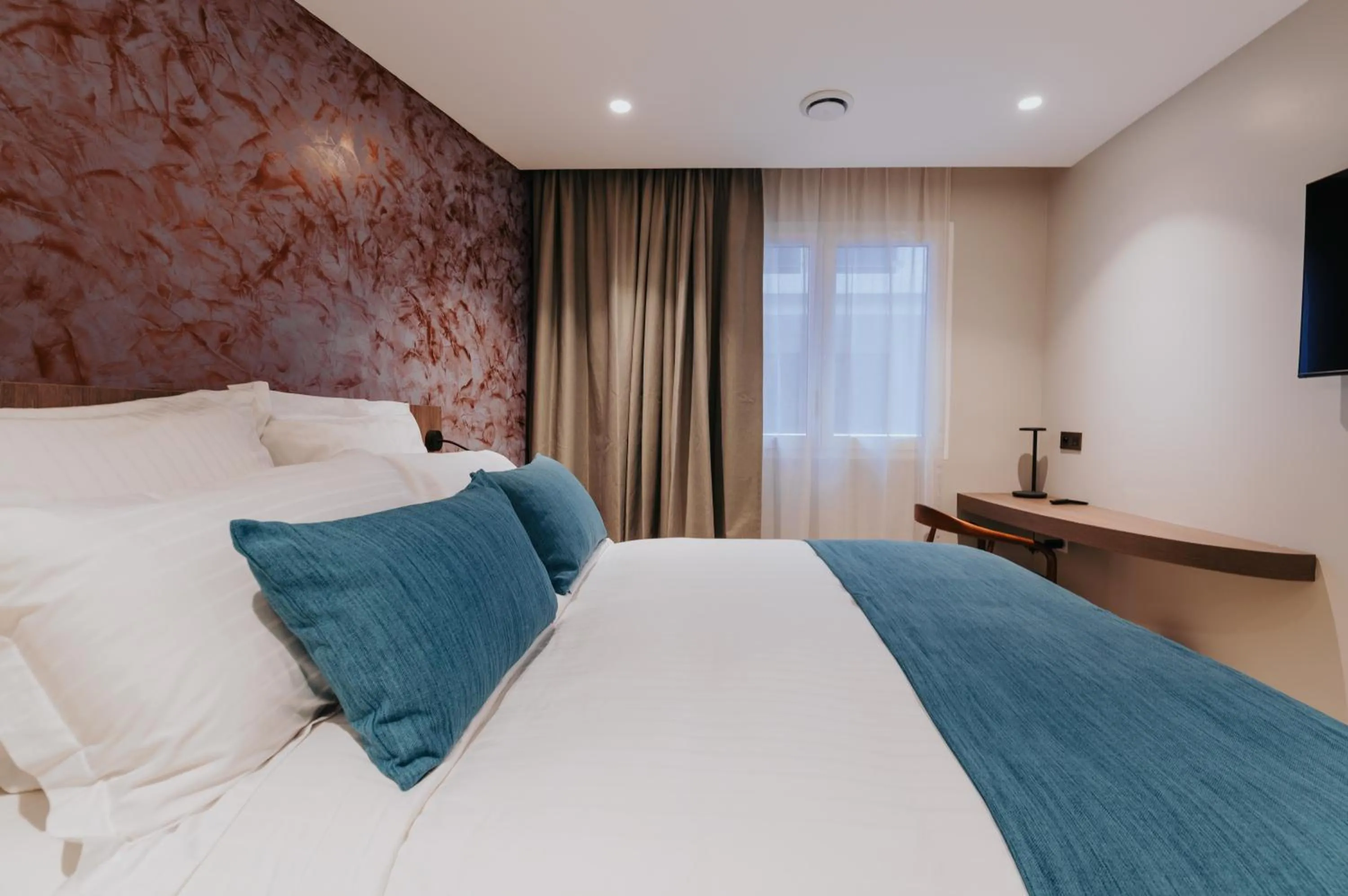 Bed in Sable Bleu Boutique Hotel