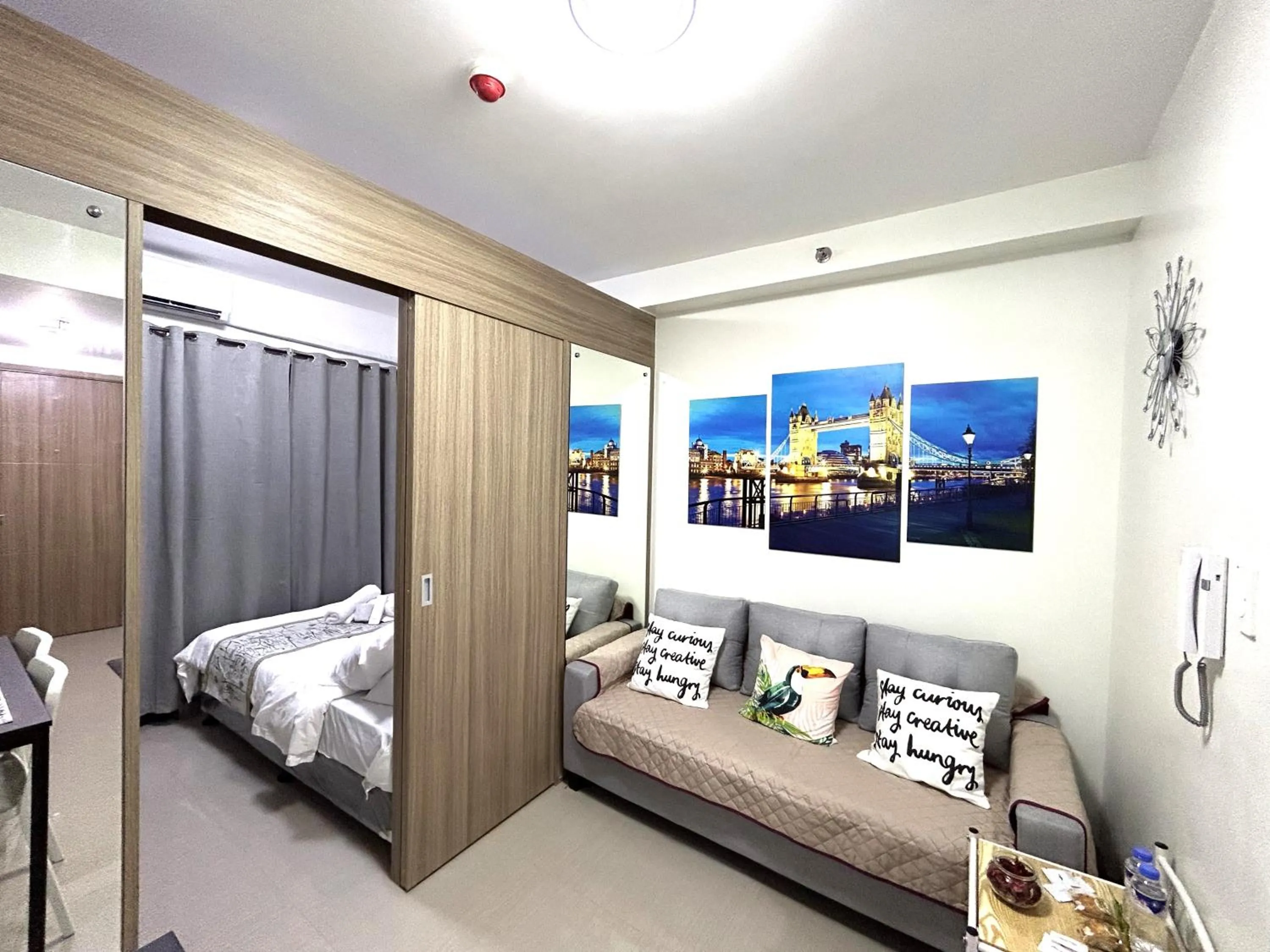 Living room, Bed in Shore Residences MOA Dynastel Staycation