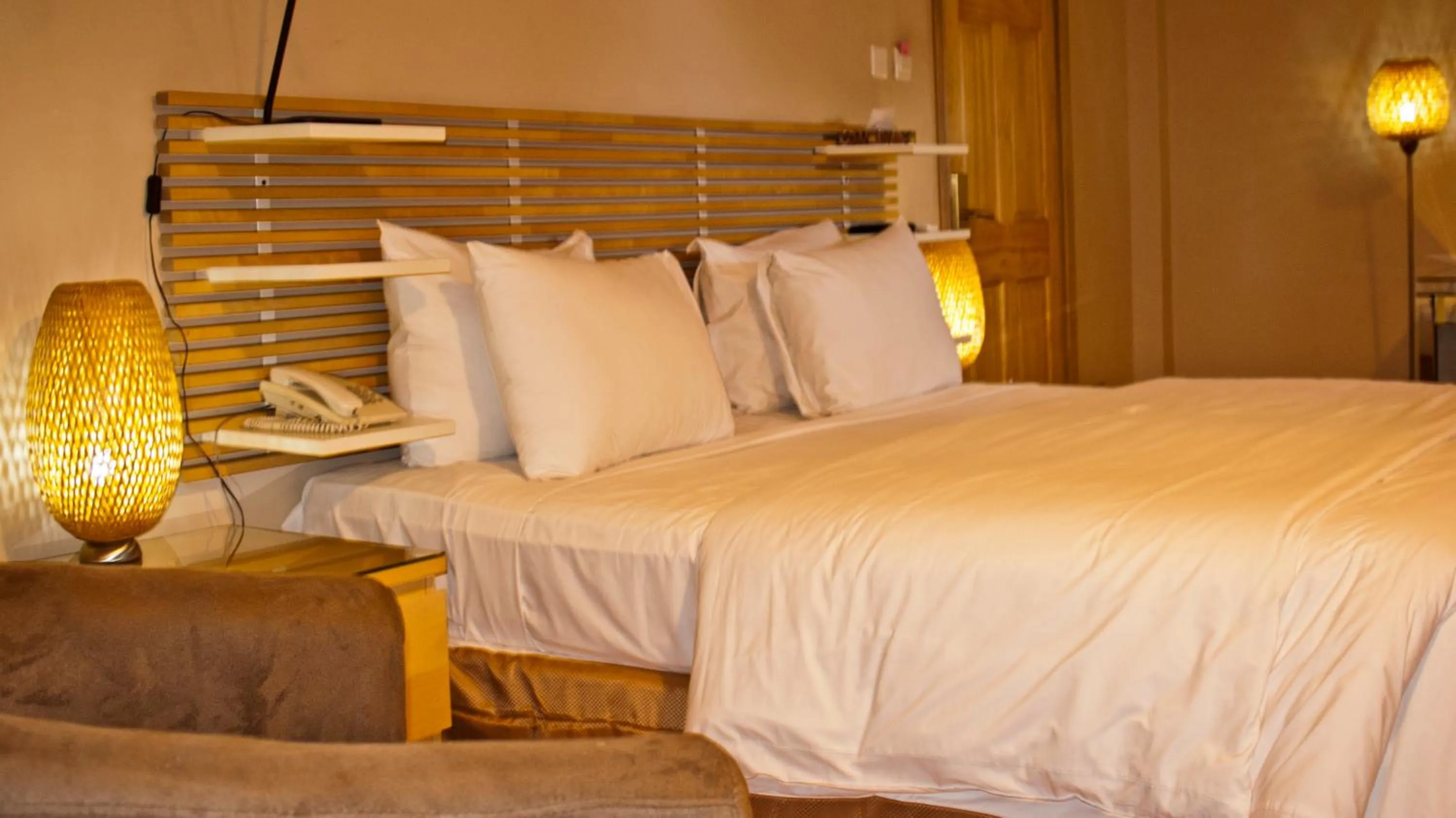 Bed in Tropical Enclave Hotel