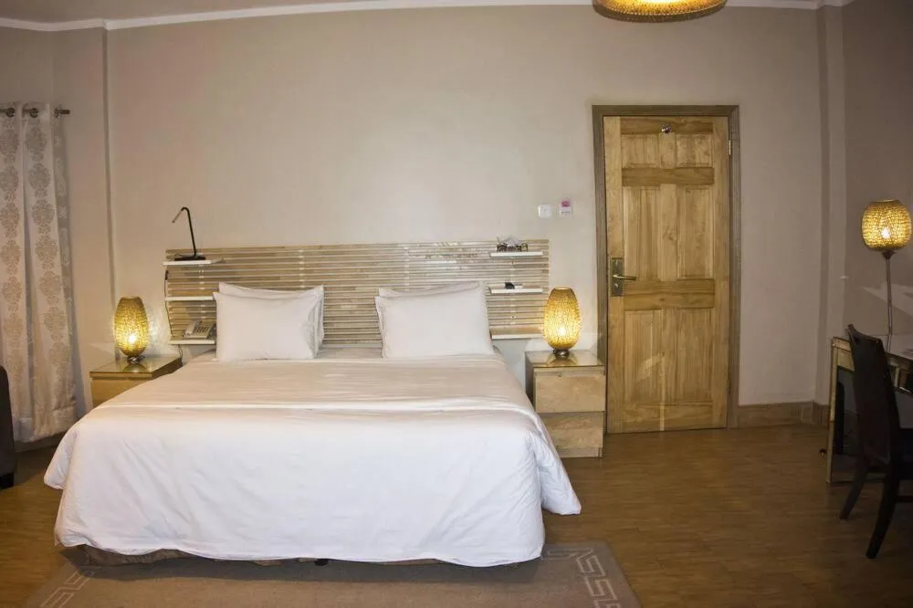 Bed in Tropical Enclave Hotel