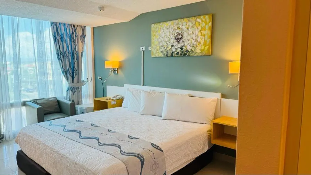 Bed in Golden Tree Hotel Belize
