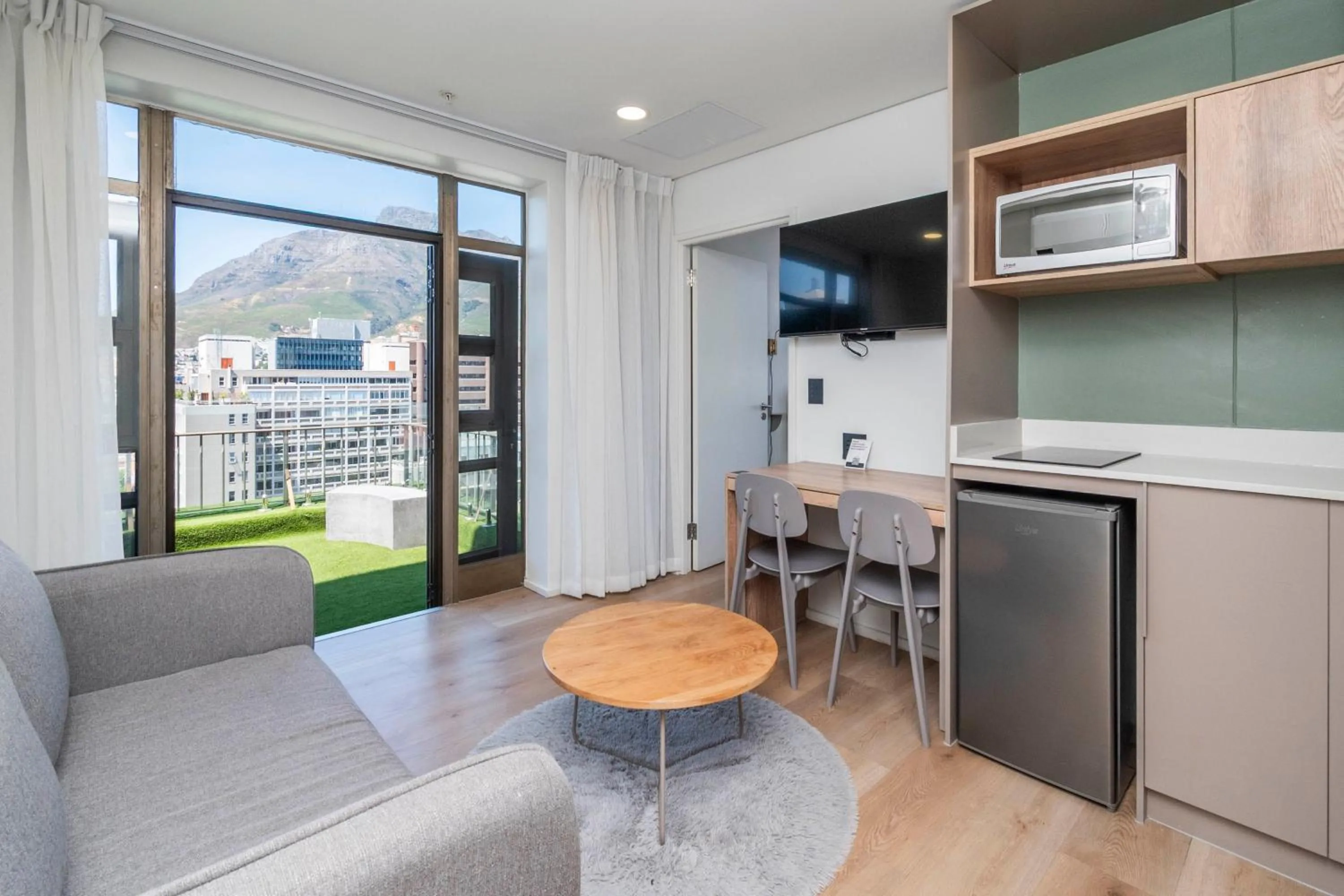 Living room in Habitat Aparthotel by Totalstay