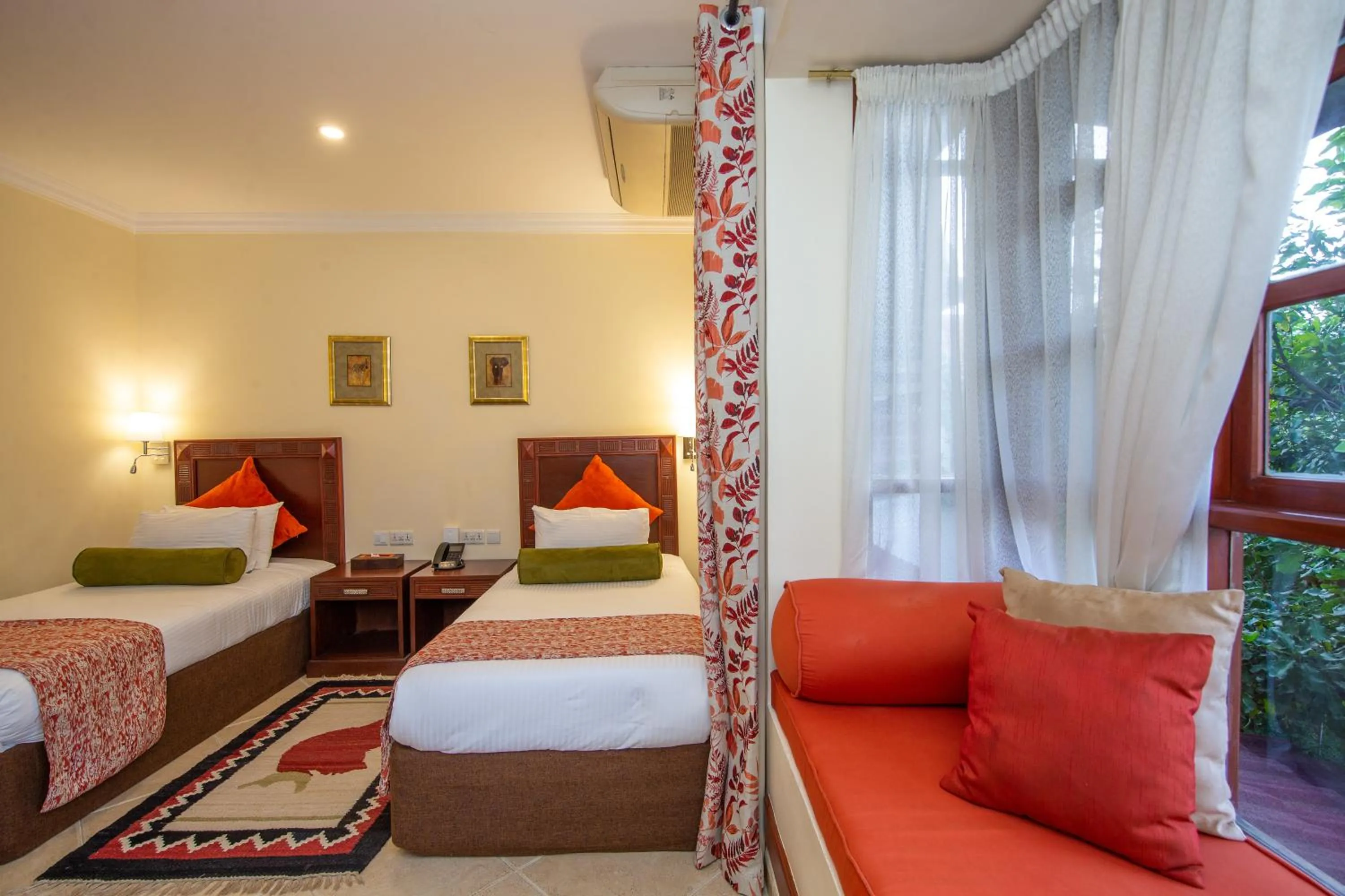 Bed in African Tulip Hotel