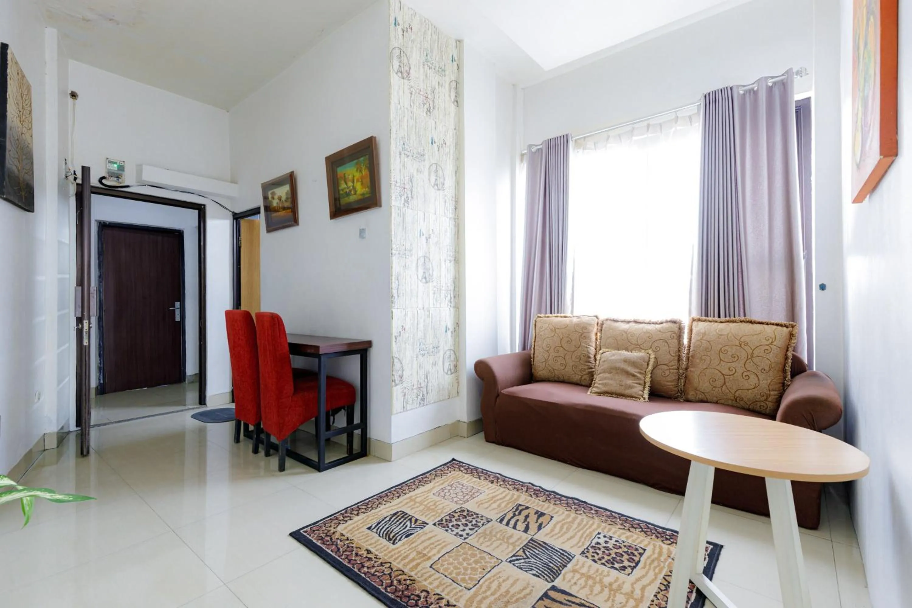 Living room in Urbanview SRB near Mall Ciputra Cibubur by RedDoorz