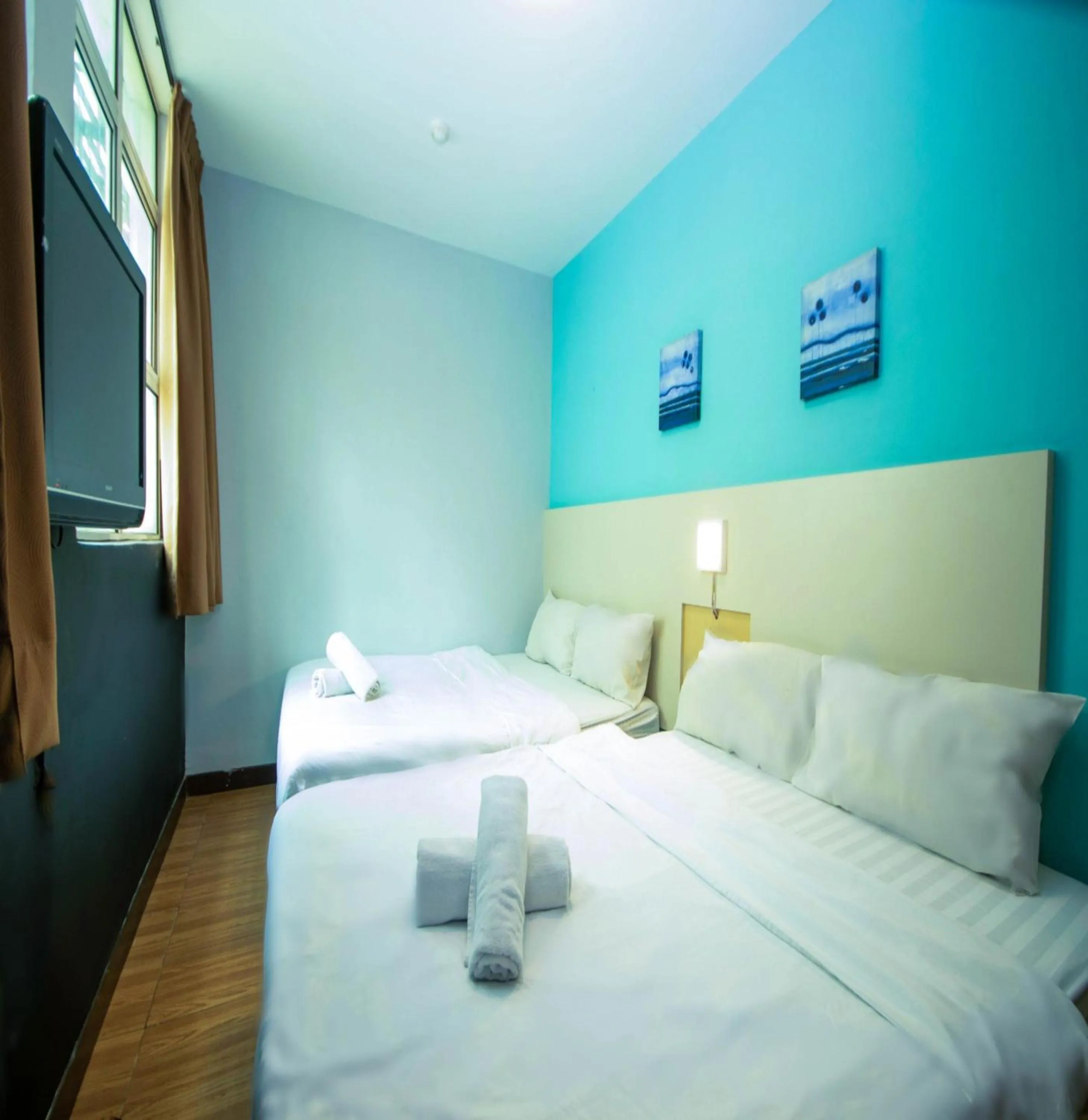 Bed in JQ Station Eight Inn