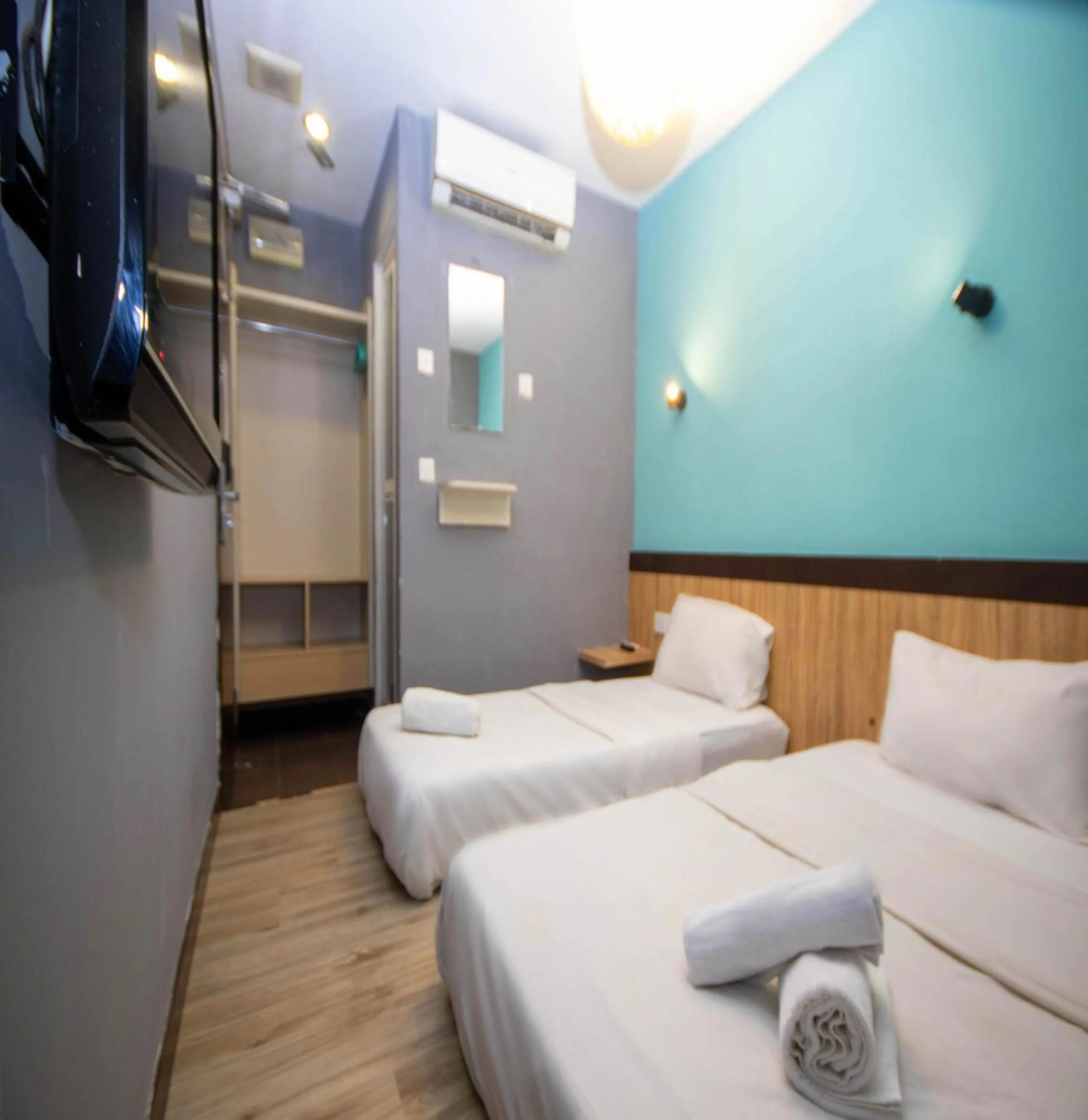 Bed in JQ Station Eight Inn