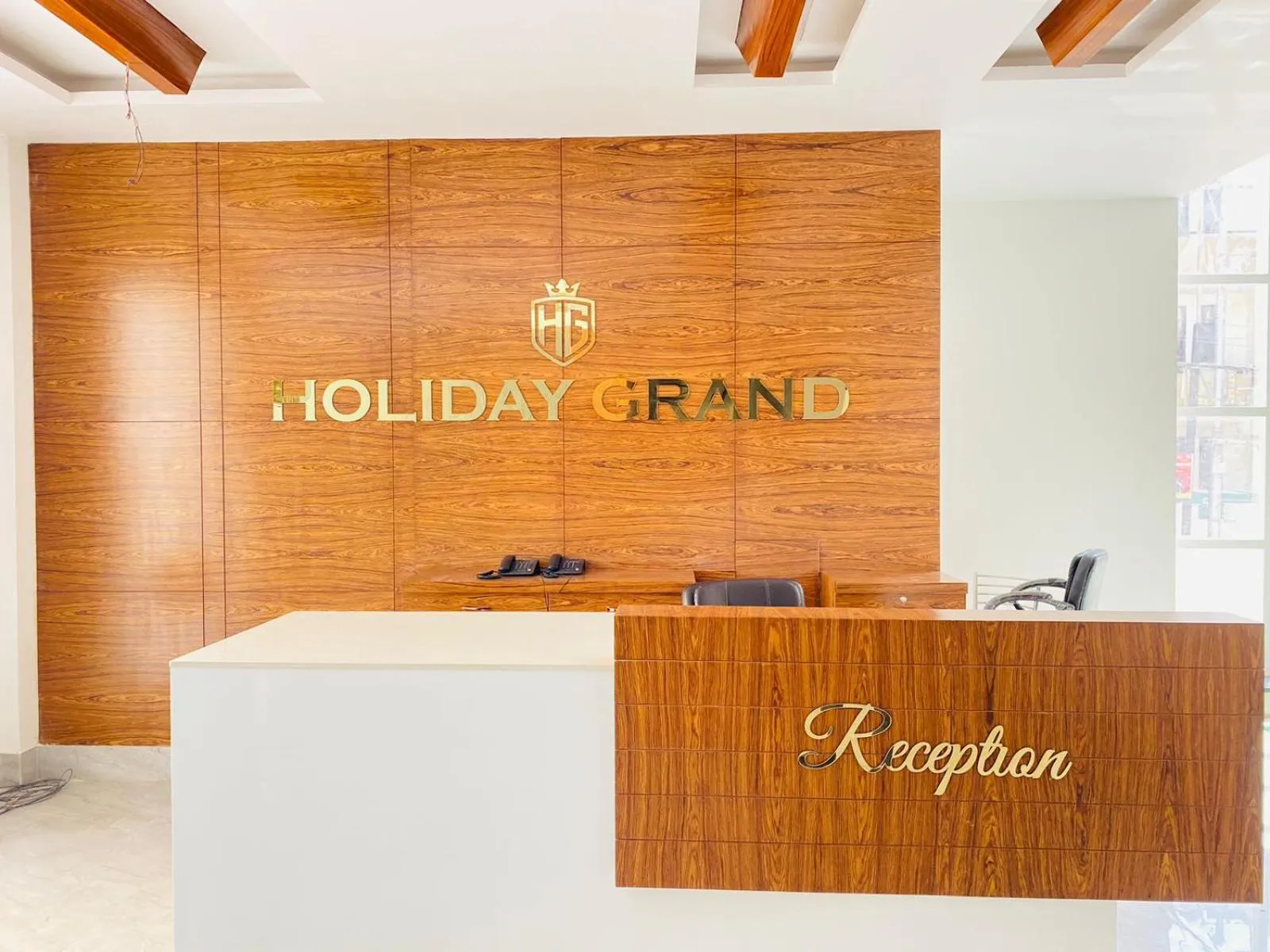 Property logo or sign in Hotel Holiday Grand