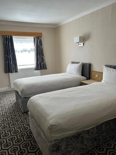 Bed in Westone Manor Hotel