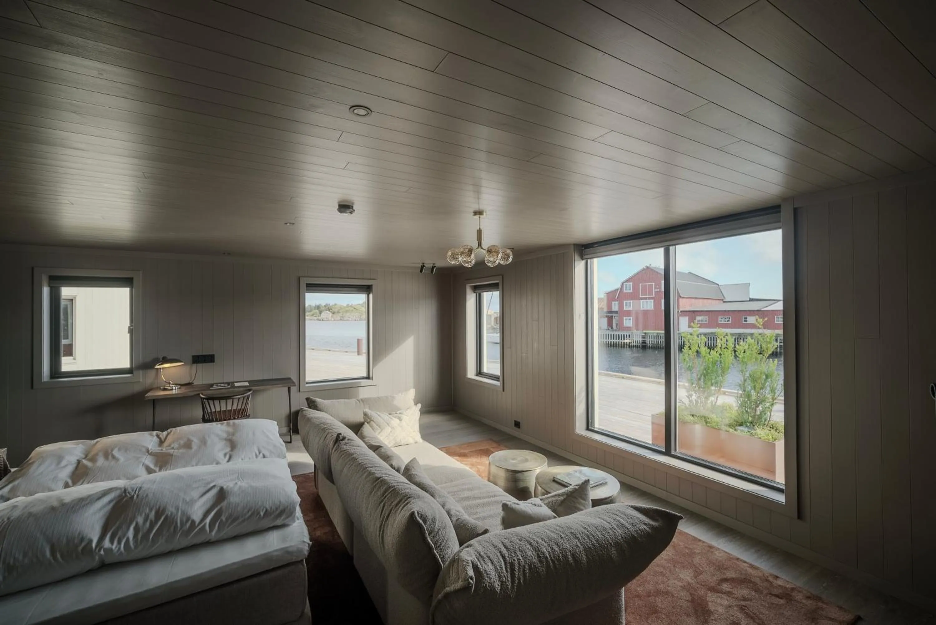 Living room, Bed in Henningsvær Bryggehotell - by Classic Norway Hotels