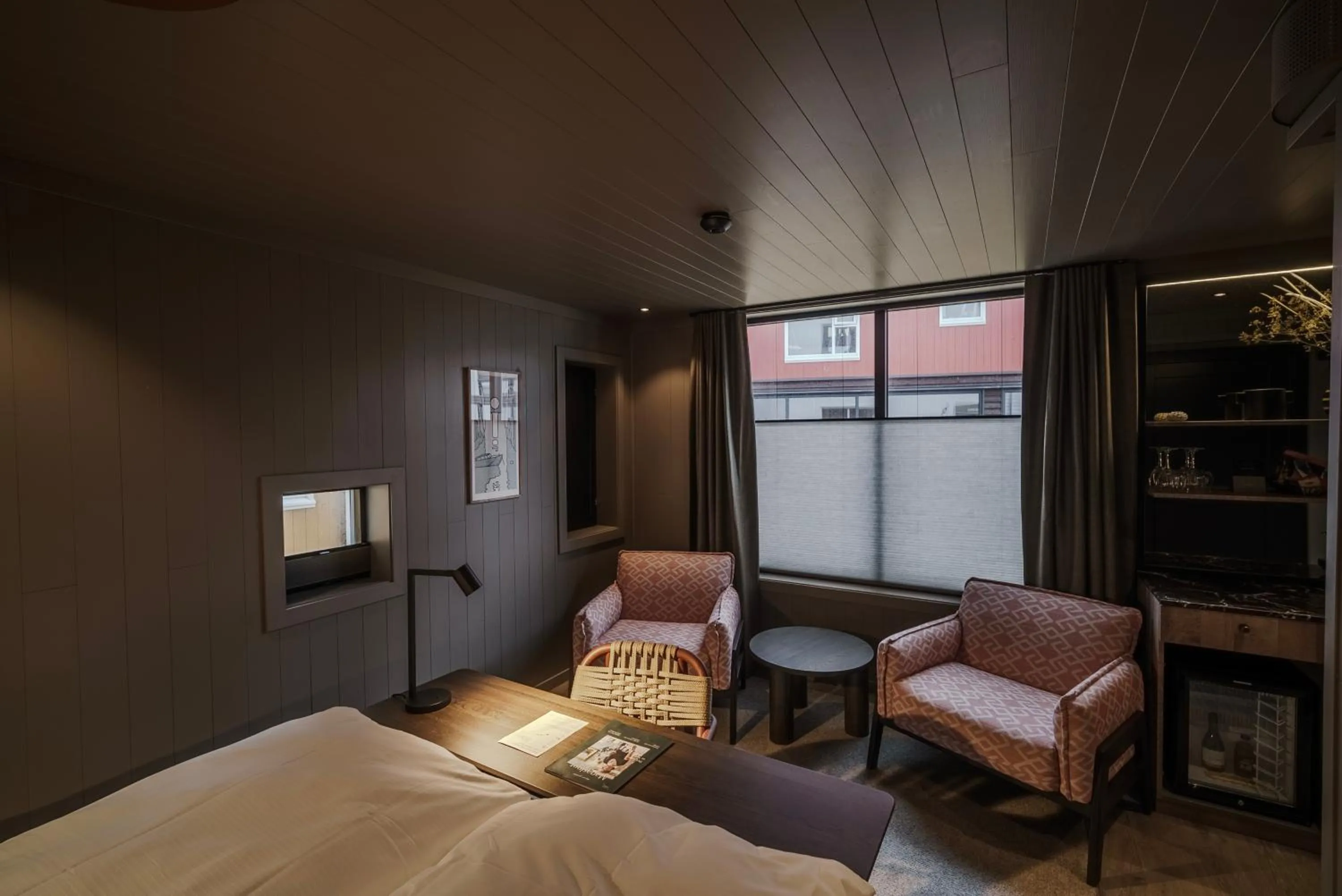 Seating area, Bed in Henningsvær Bryggehotell - by Classic Norway Hotels