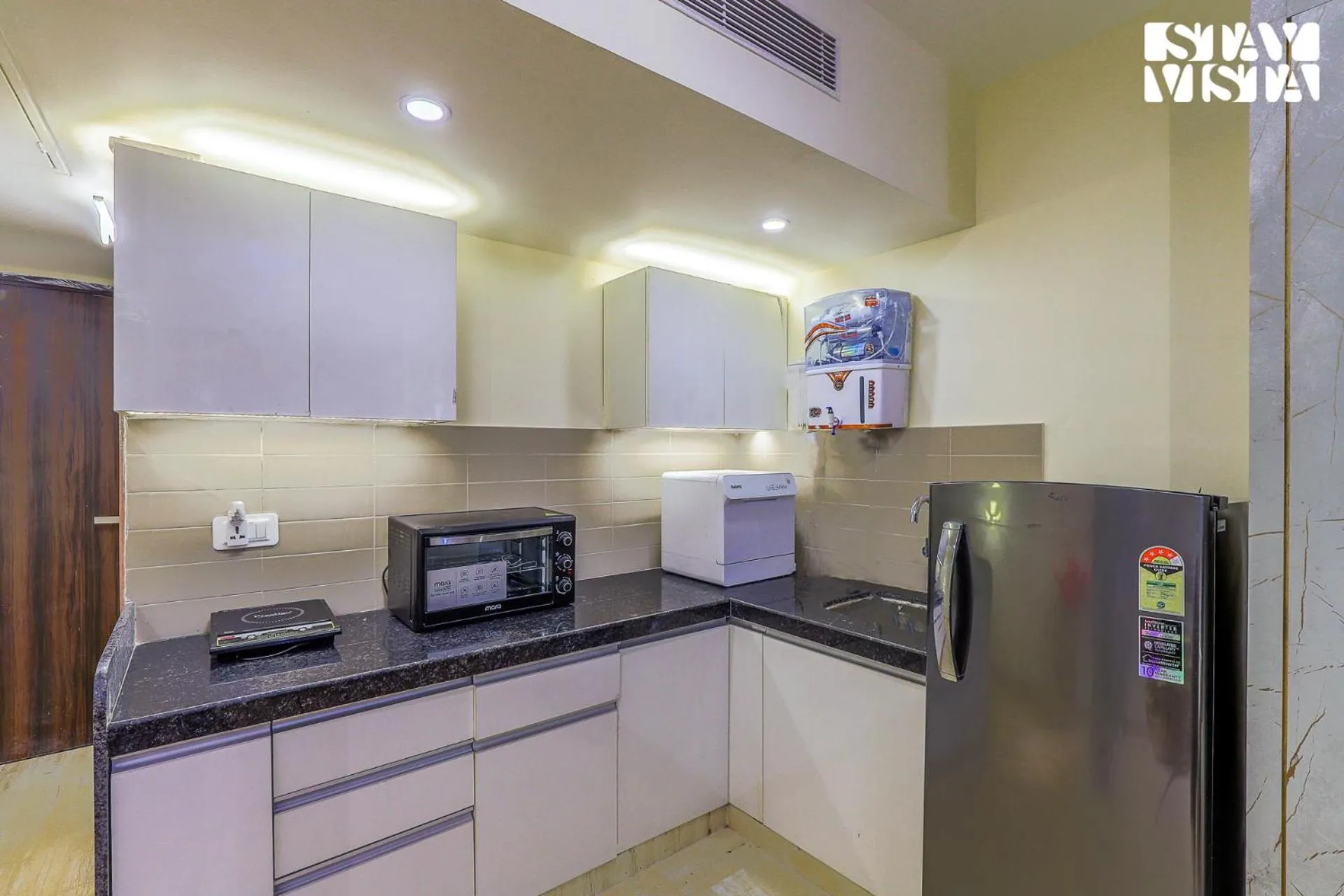 Kitchen or kitchenette in StayVista at Cityscape with Rooftop Pool - Jaipur
