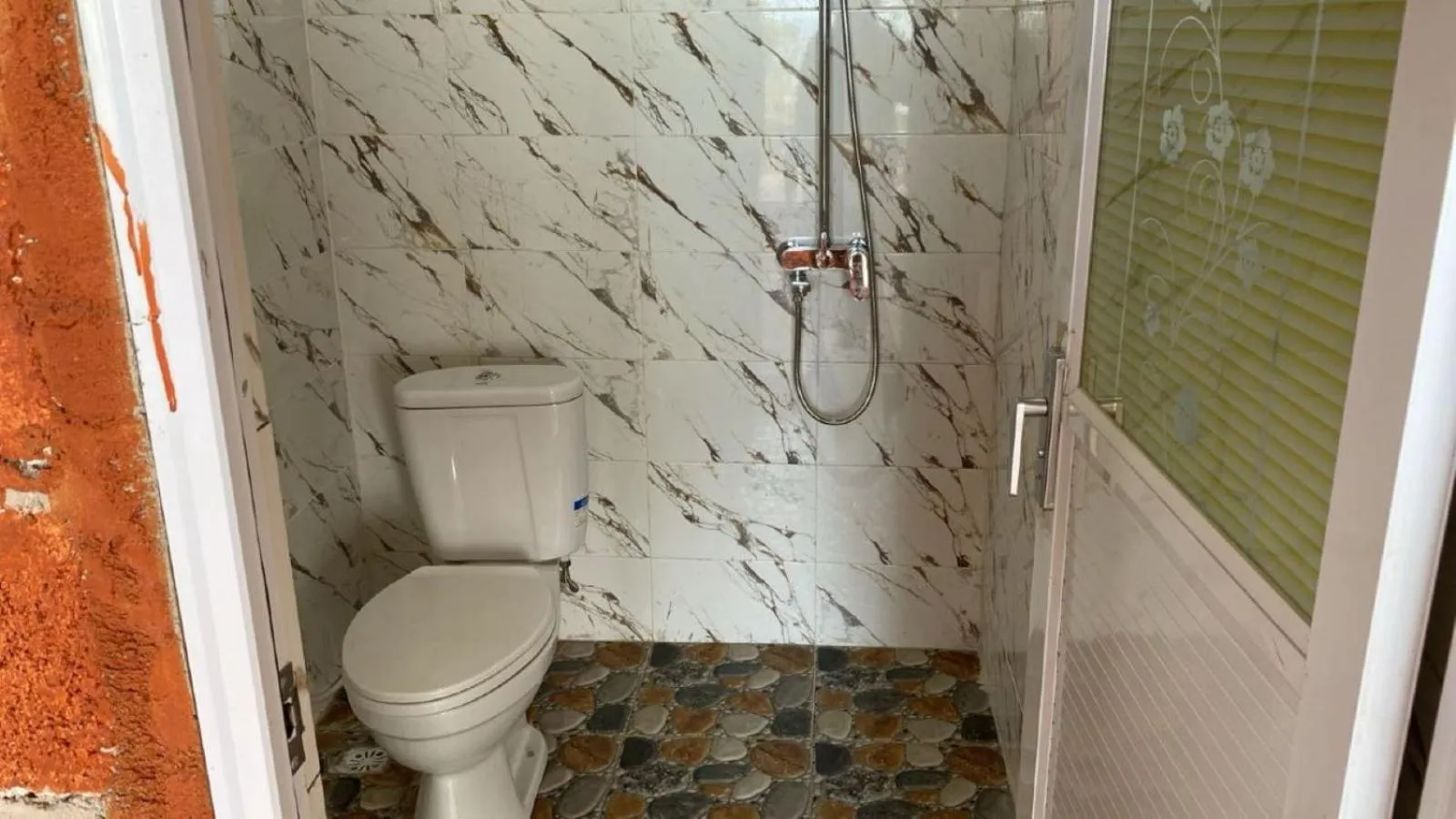 Toilet in Suwehan Beach Cliff House by BIJAK