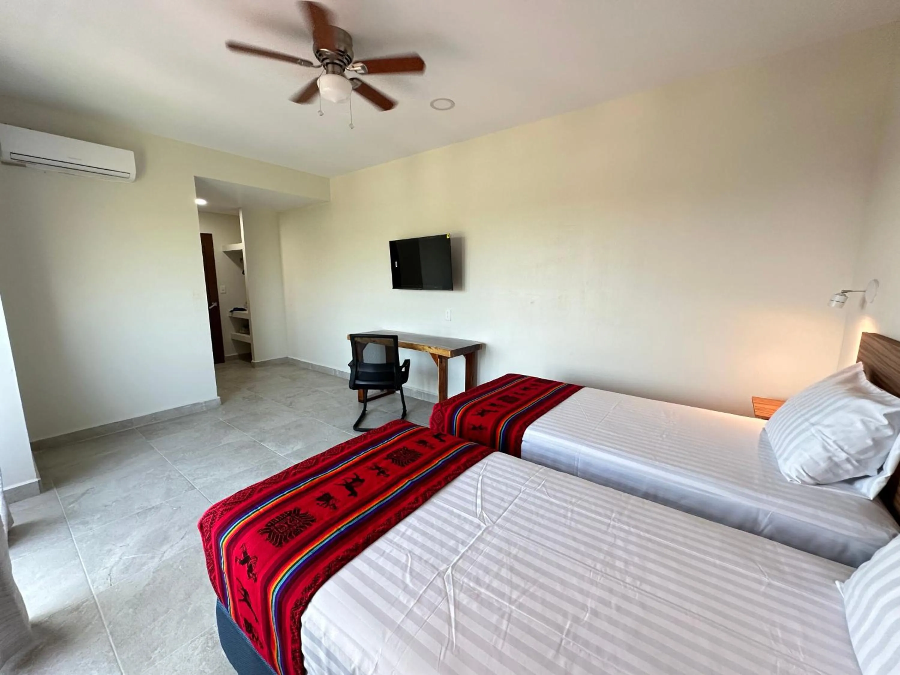 Communal lounge/ TV room, Bed in Oneiro Suites with Sea View