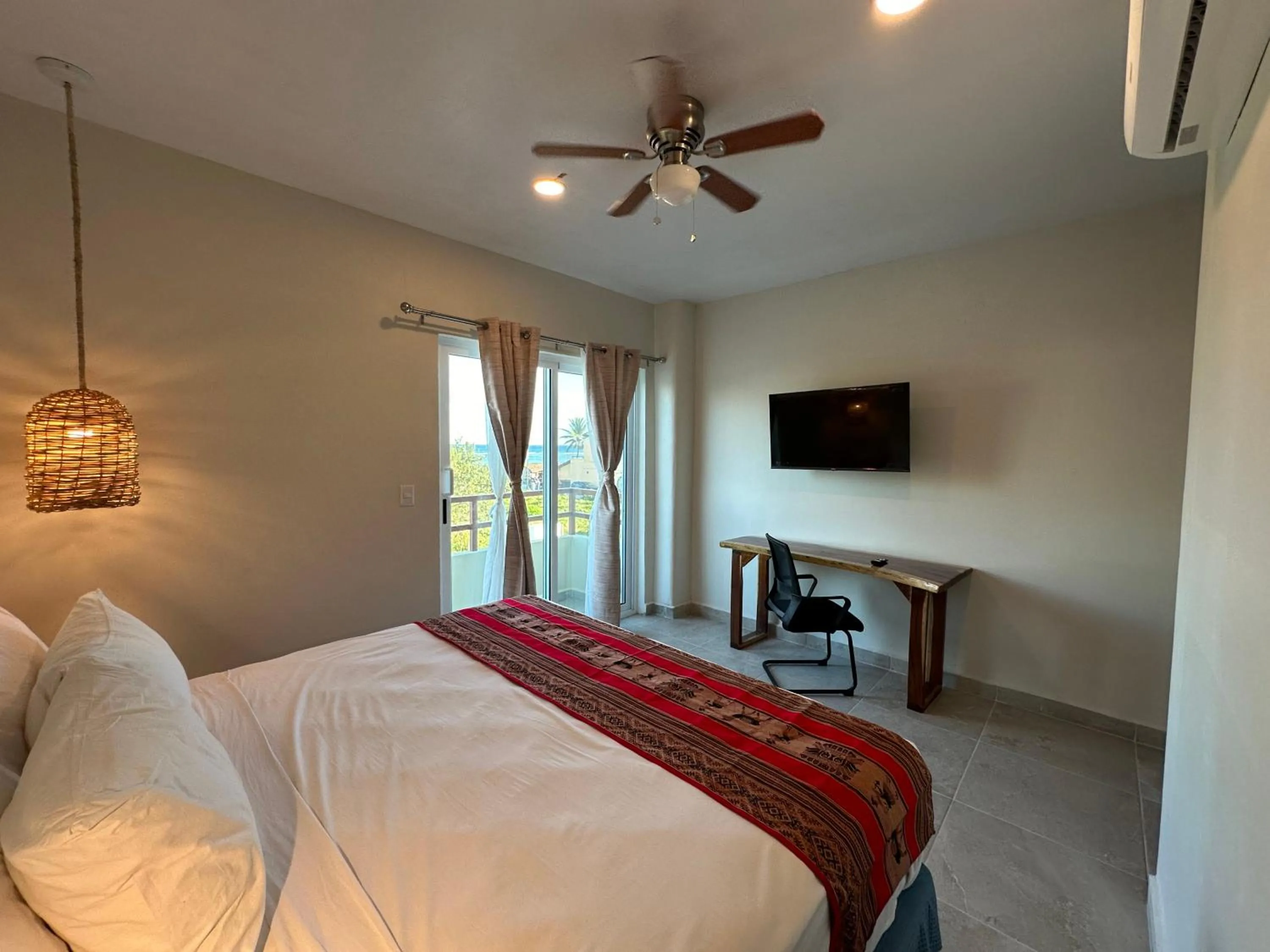 Communal lounge/ TV room, Bed in Oneiro Suites with Sea View