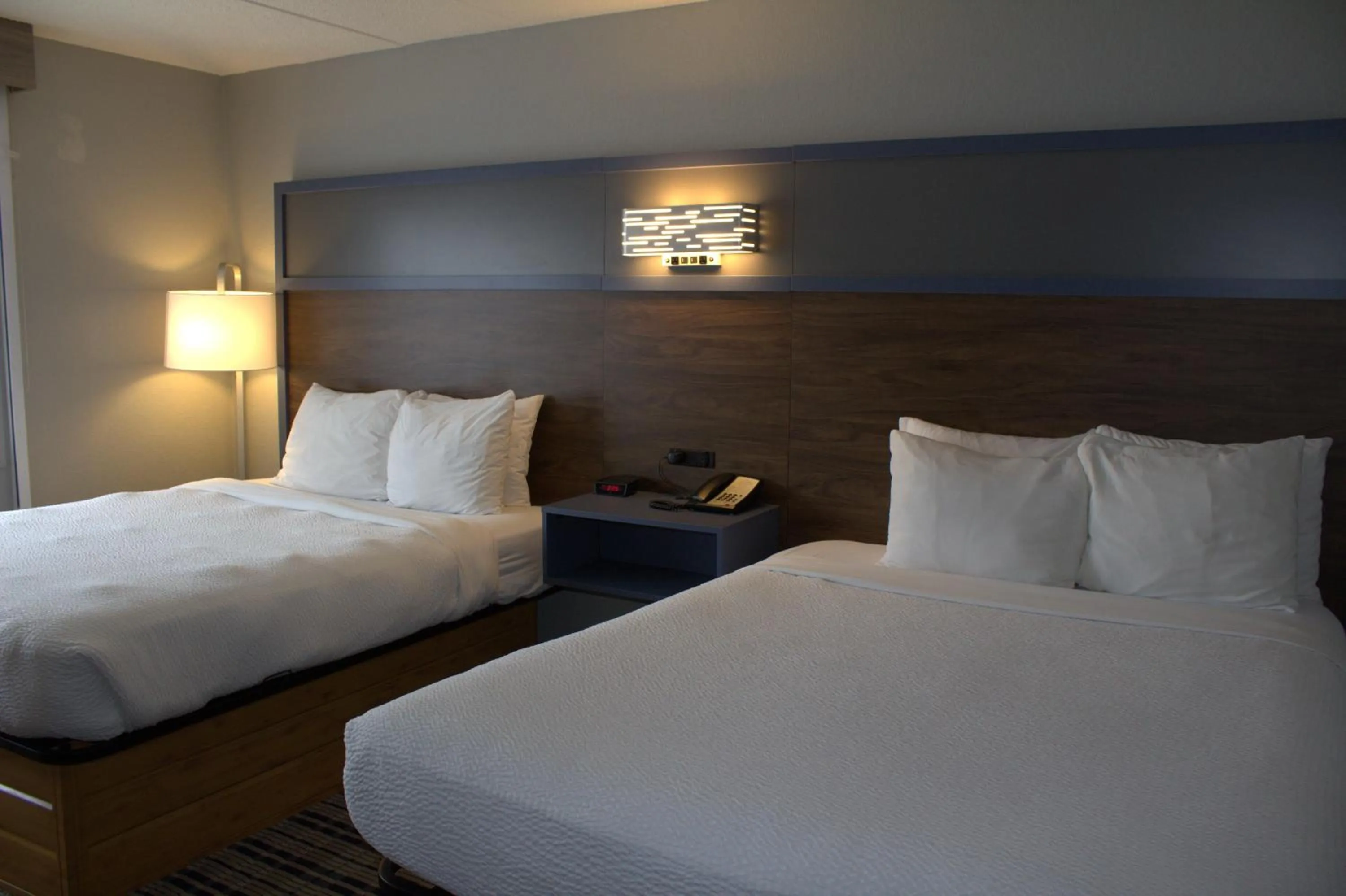 Bed in AmericInn by Wyndham Worthington