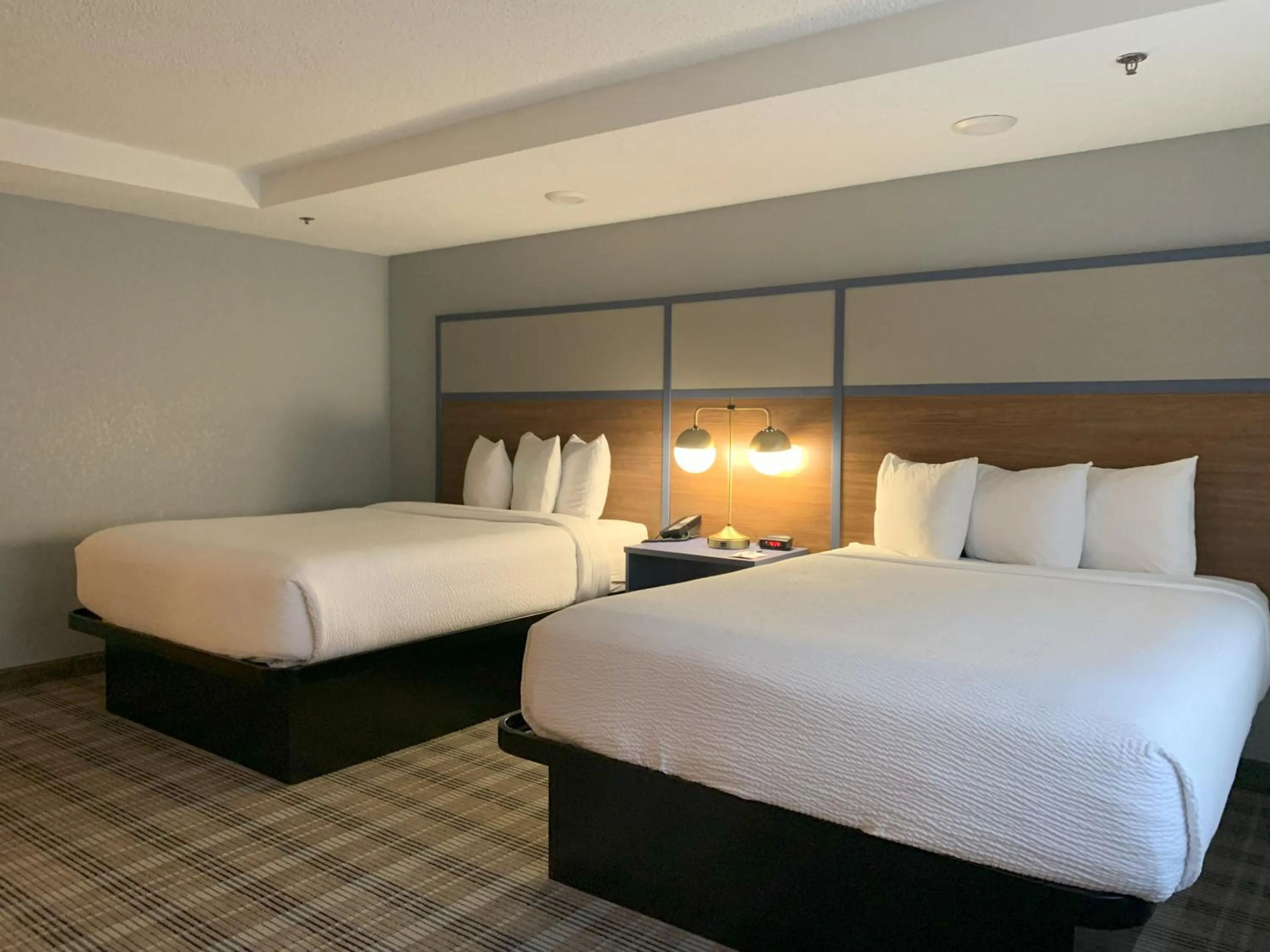 Bed in AmericInn by Wyndham Worthington