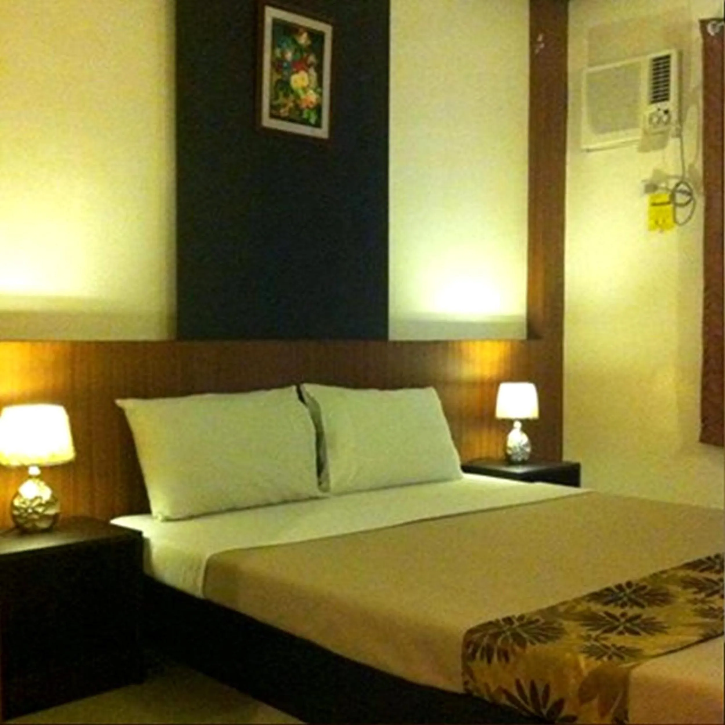 Bed in Pacific Palm Suites Davao powered by Cocotel