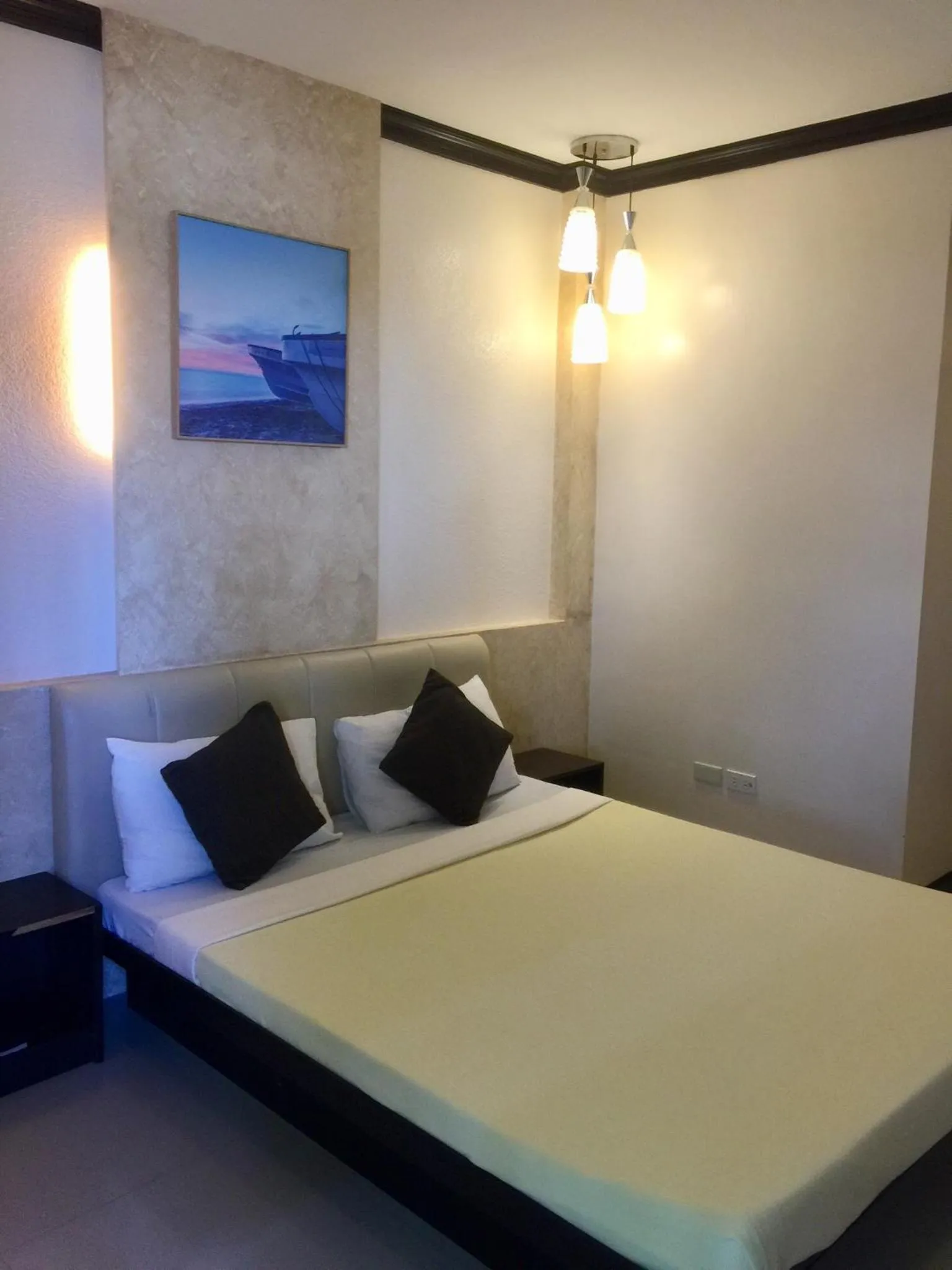 Bed in Pacific Palm Suites Davao powered by Cocotel