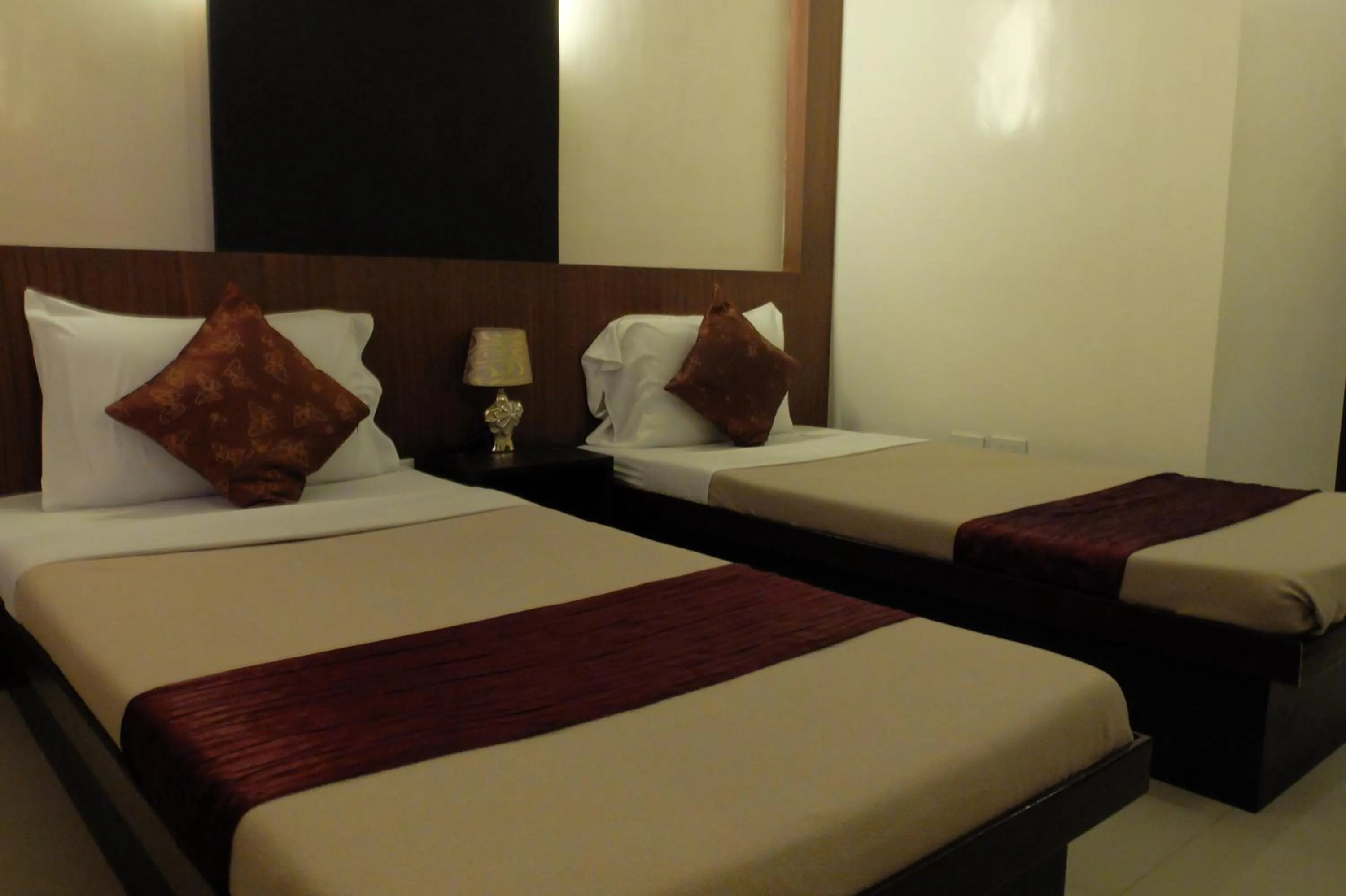 Bed in Pacific Palm Suites Davao powered by Cocotel