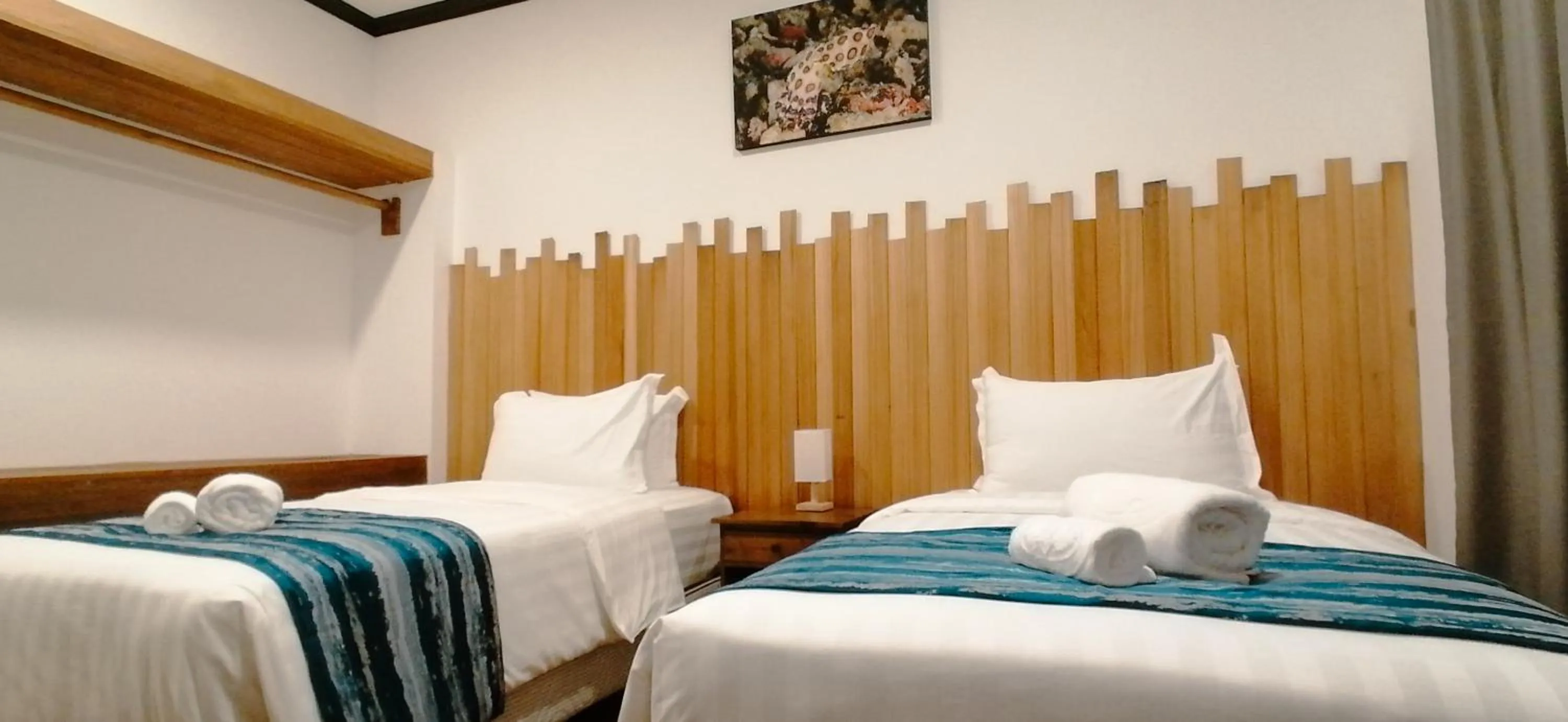 Bed in Mamutik Island Lodge