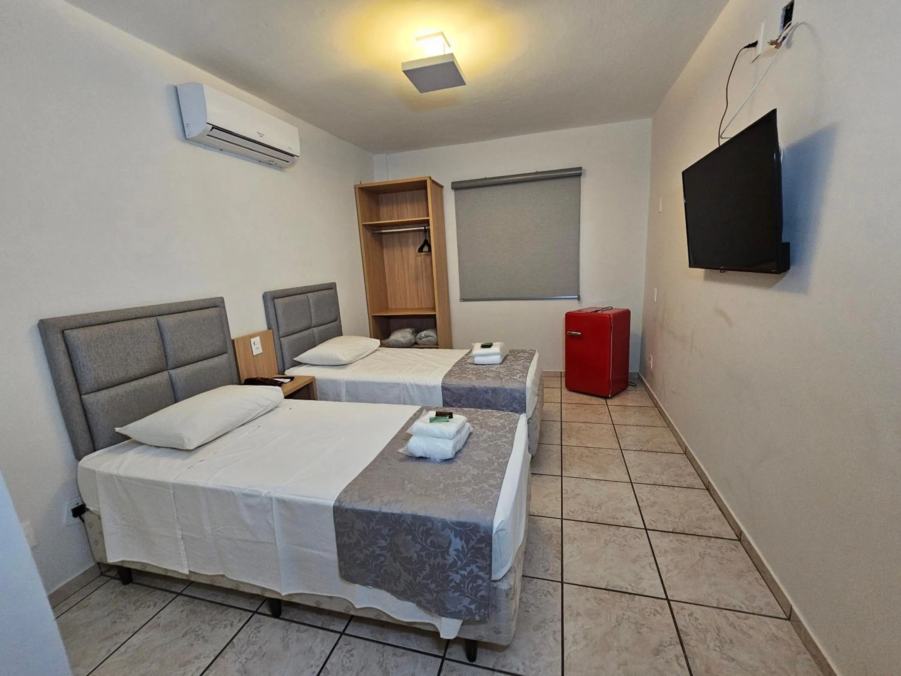 Bed in Optimum Plaza Hotel