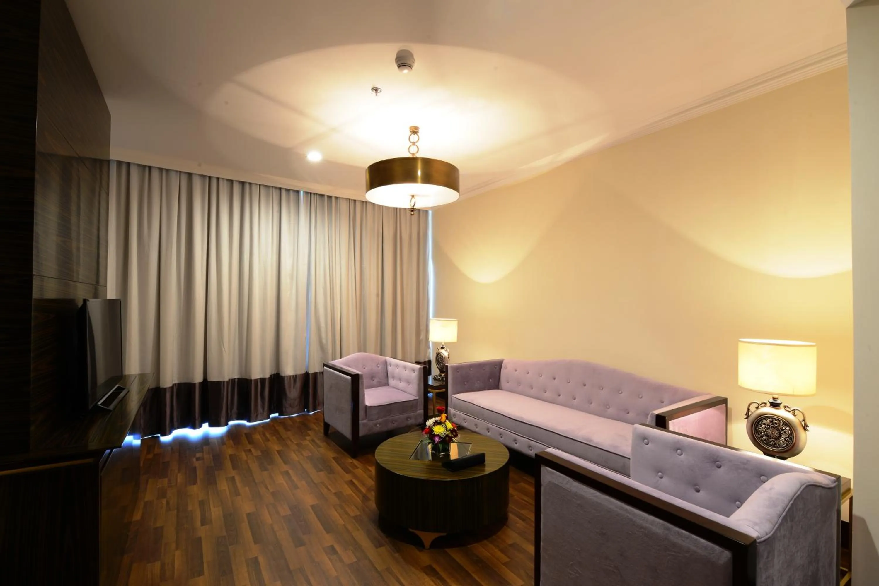 Living room, Bed in Landmark Premier Hotel