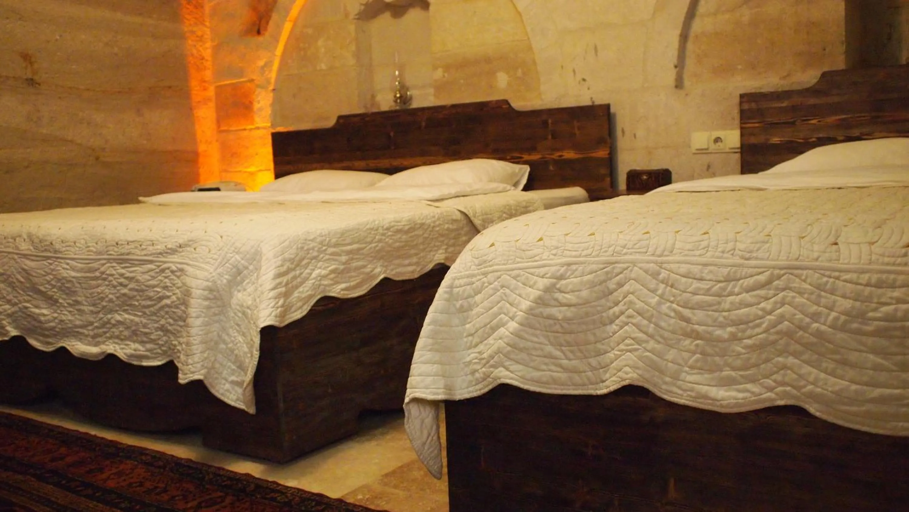 Bed in Family Cave Suite Hotel