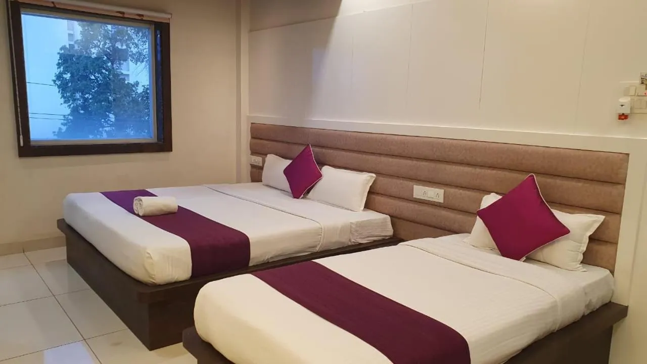 Bed in Hotel Siddhali Inn