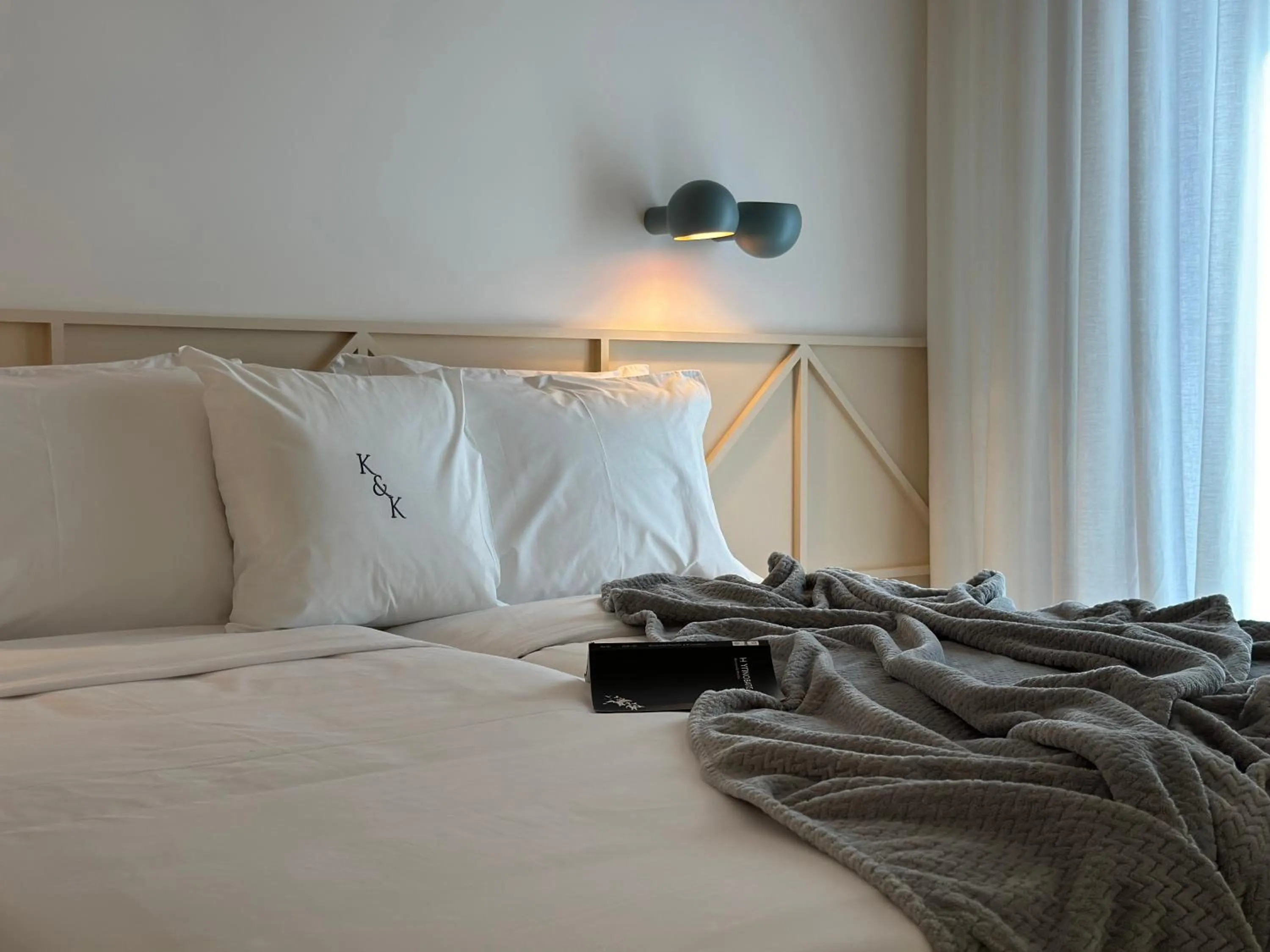 Bed in AIONION RESIDENCES by K&K