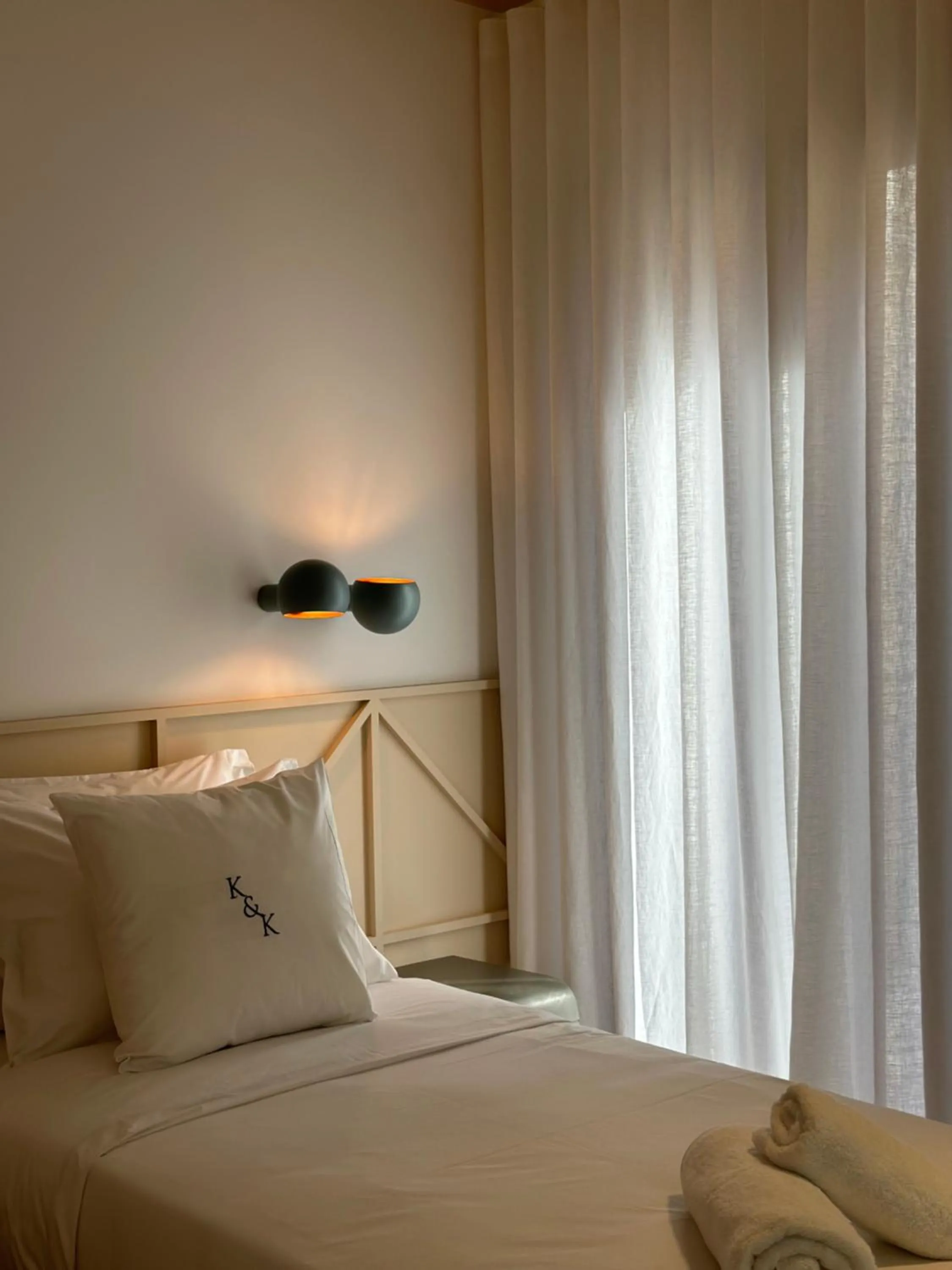 Bed in AIONION RESIDENCES by K&K