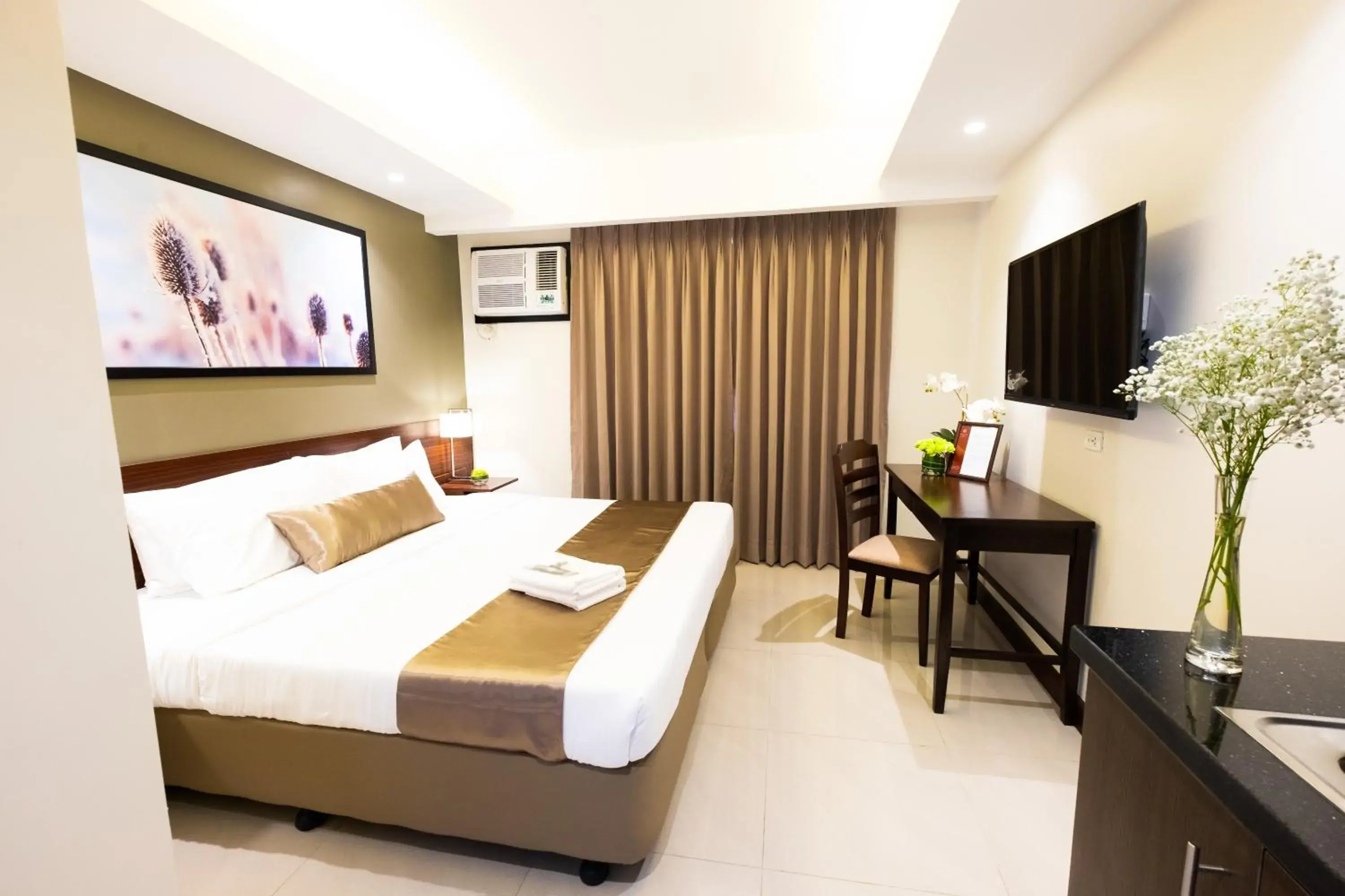 Communal lounge/ TV room, Bed in Soleil Suites Cebu Communal lounge/ TV room, Bed in Soleil Suites Cebu