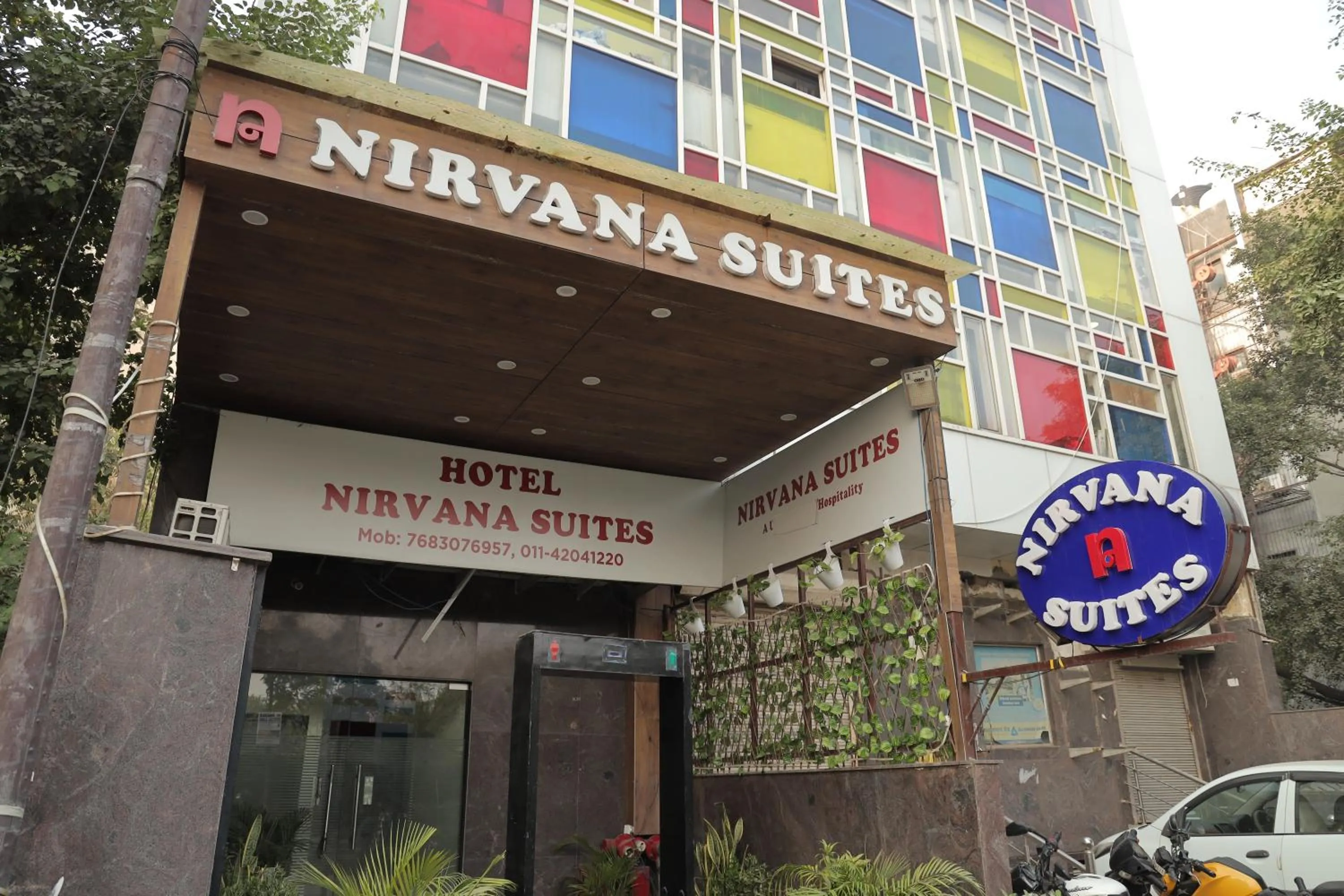 Property logo or sign in Hotel Nirvana Suites